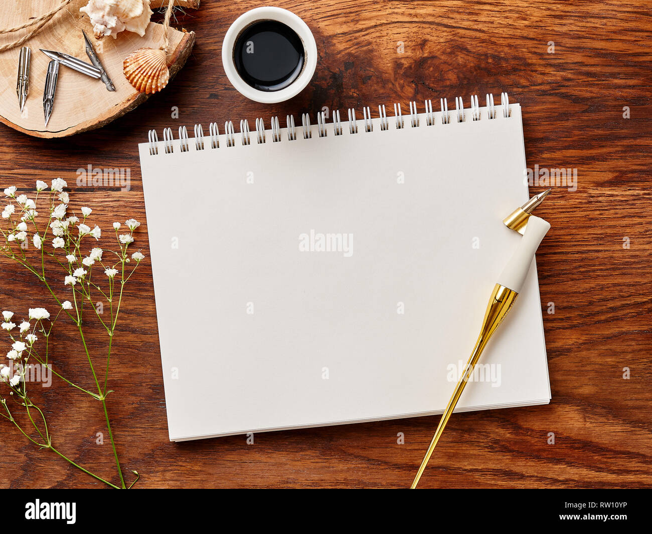 Mock up of blank artist sketchbook on wooden background with