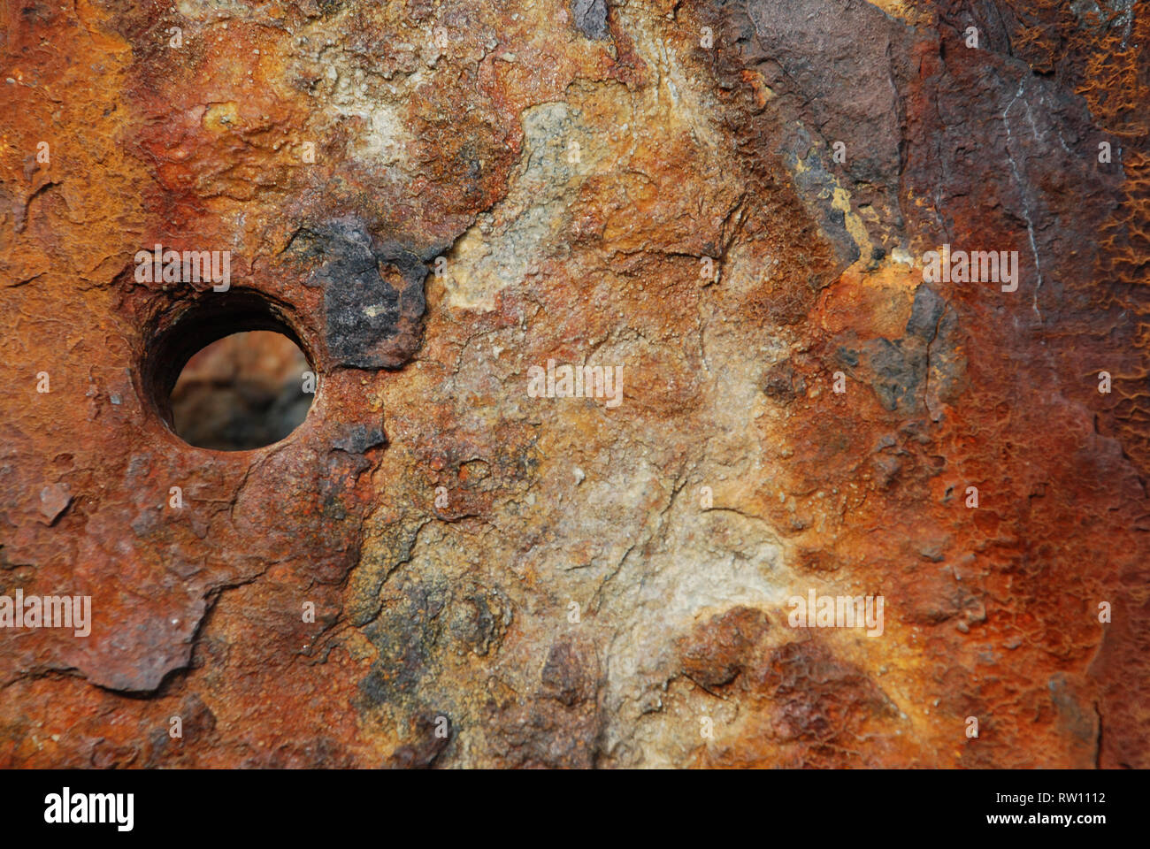 close up of a rusting coastal groin showing flaking, discolouration and damage through weathering and time Stock Photo