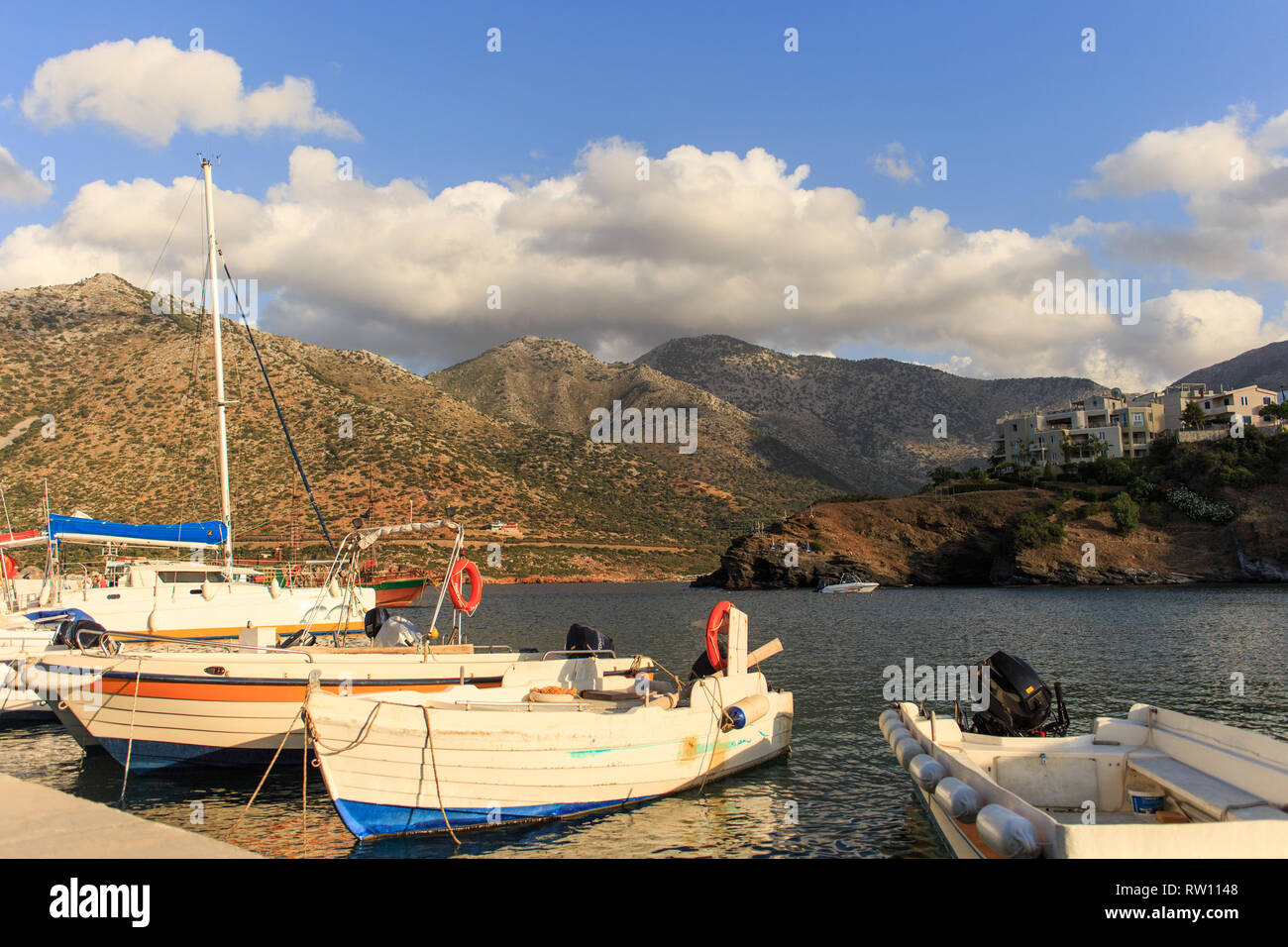 small fishing boats with mountains at background in Crete, Rethymno, Greece. Stock Photo