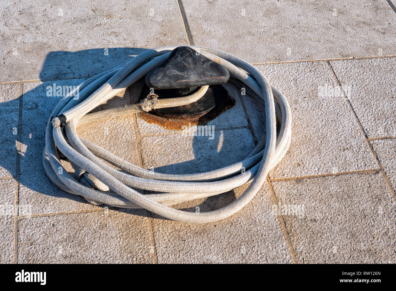 Bollard and mooring lines on the pier in the Mediterranean Stock Photo