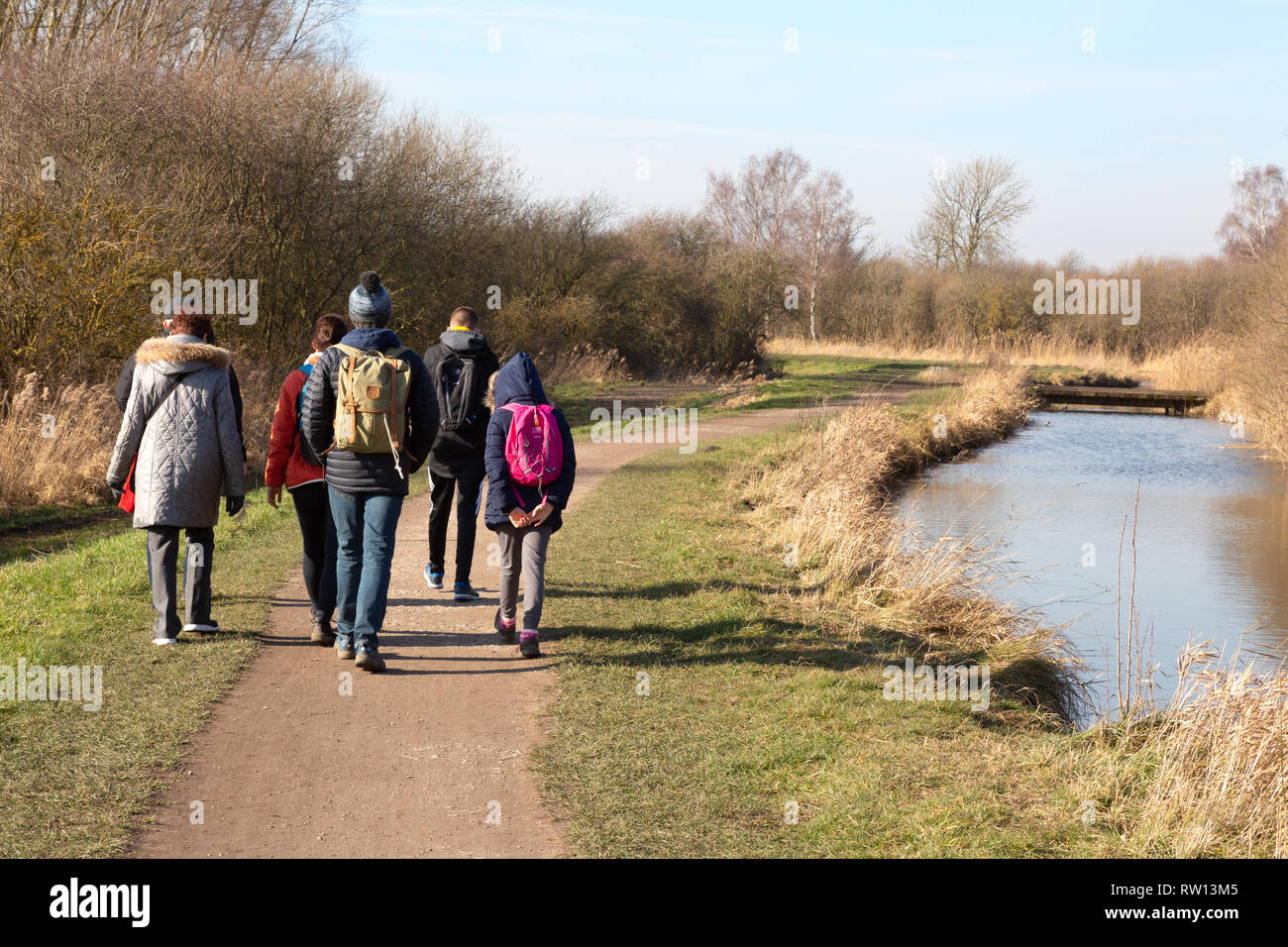 People walking beside the fens in February ,  Cambridgeshire East Anglia UK Stock Photo