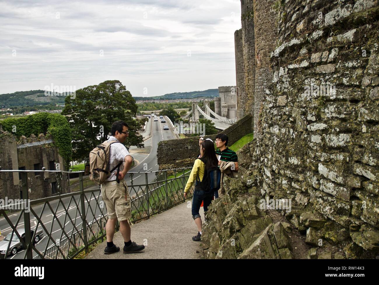Tourists pose for photographs, Conwy Castle, Conwy, North Wales, UK Stock Photo