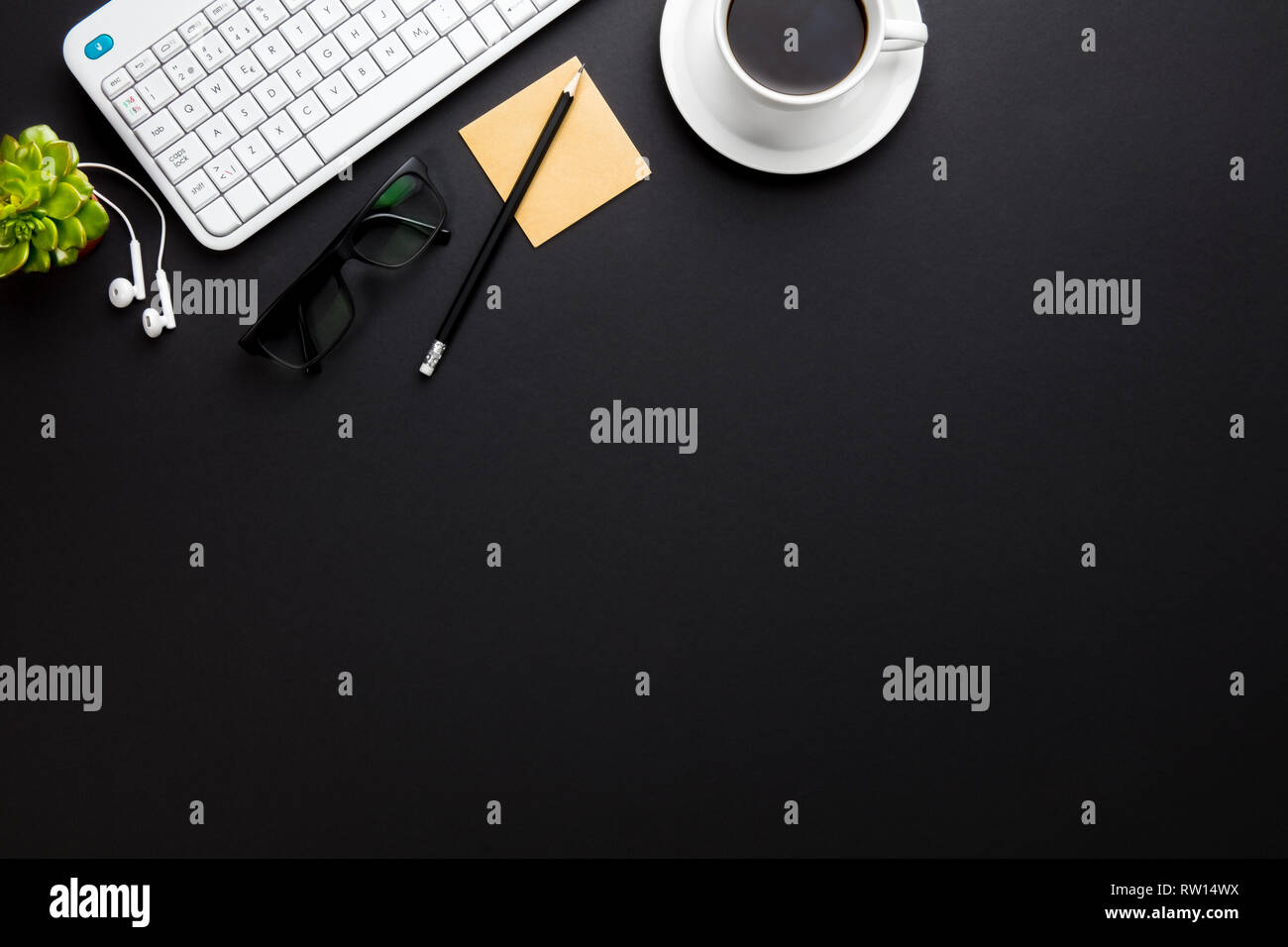 Keyboard With Coffee Cup And Office Supplies On Gray Desk Stock Photo
