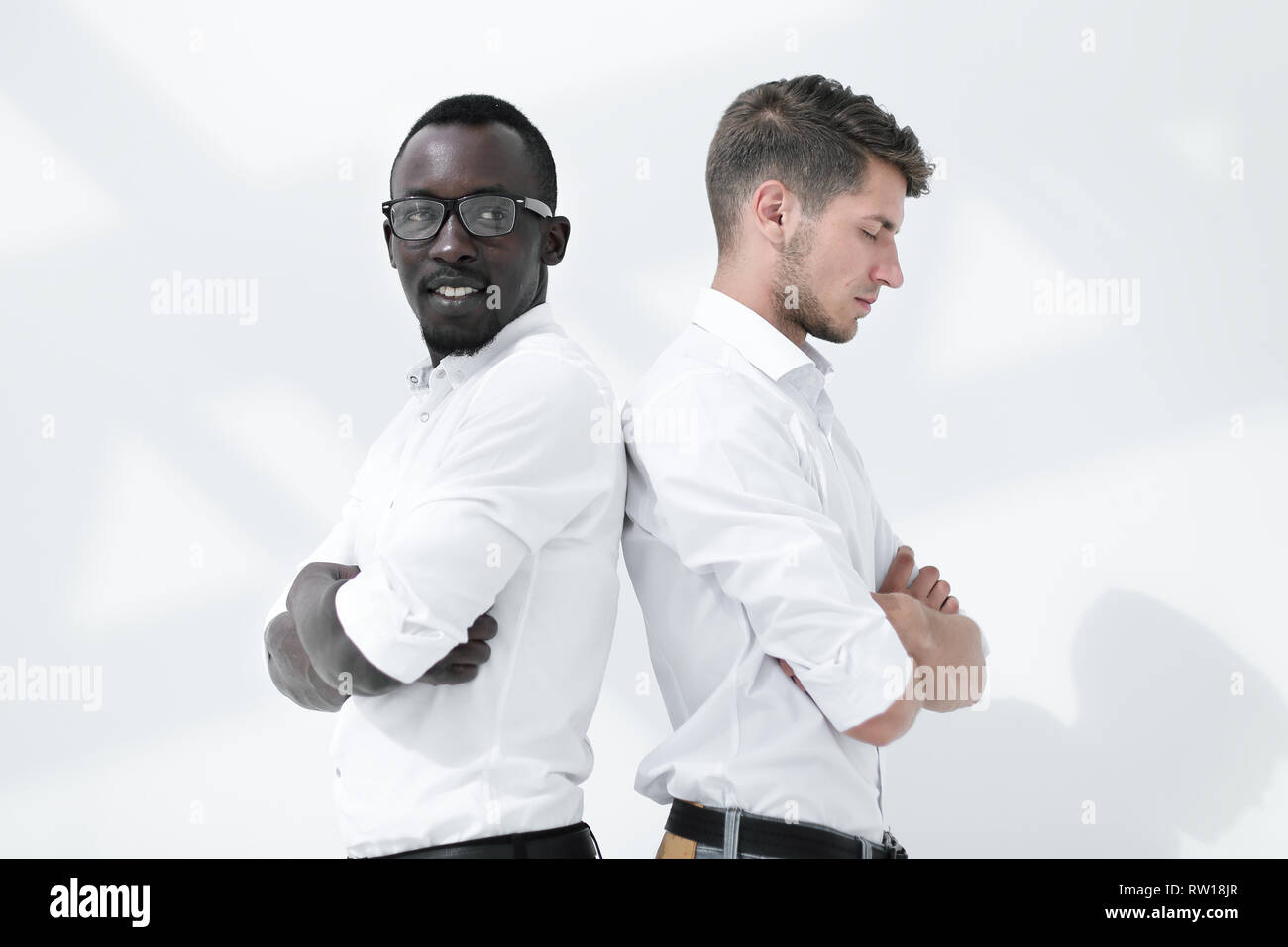 two young business partners standing back to back Stock Photo - Alamy