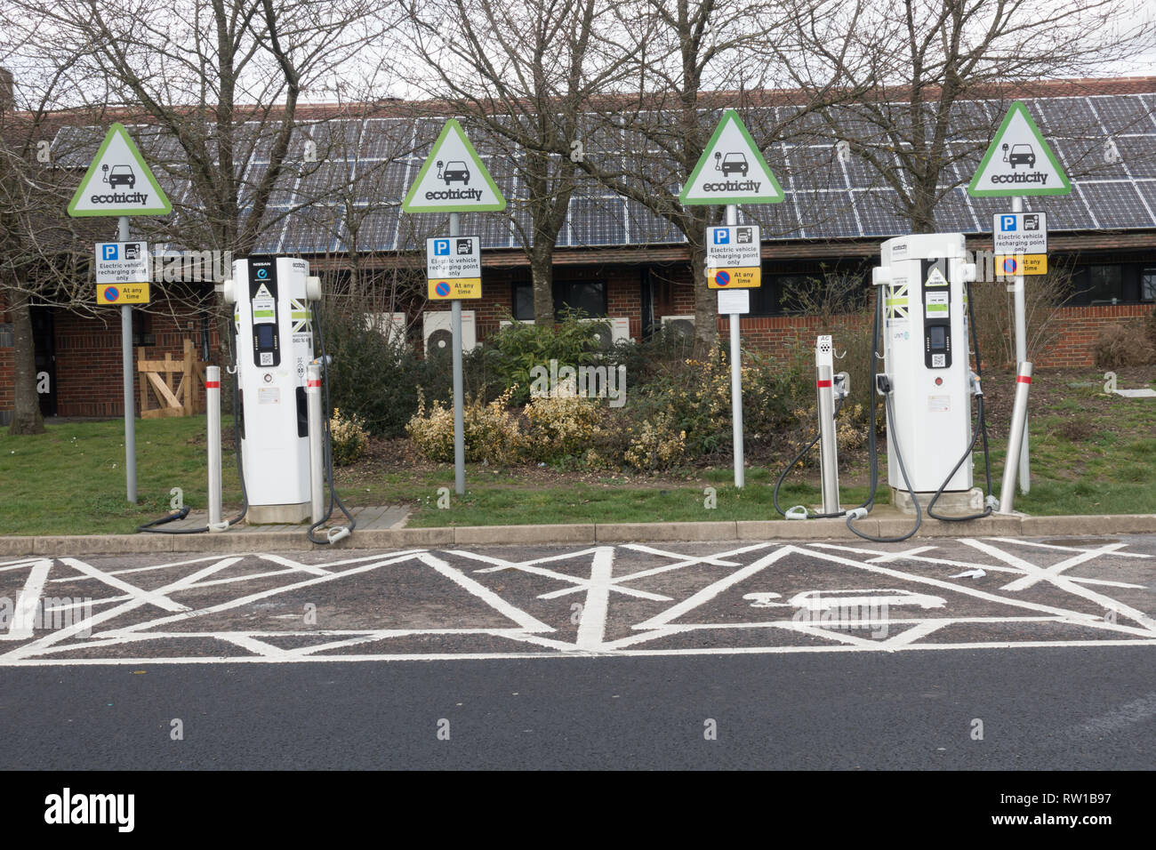 Electric car charging points at service area. British Isles Stock Photo