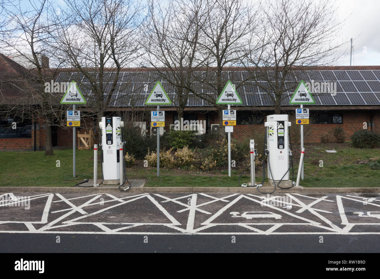 Electric car charging points at service area. British Isles Stock Photo