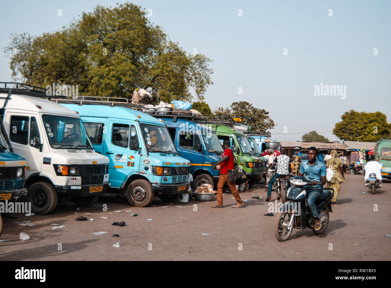 A photo of buses parking at a busy bus station in Bolgatanga, Ghana Stock Photo