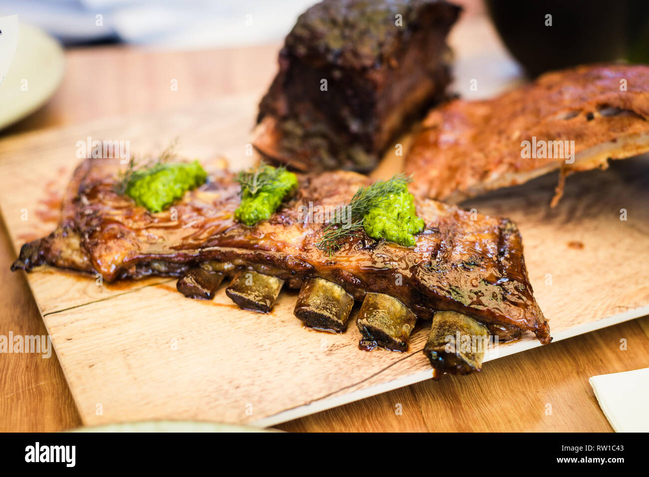 sticky lamb ribs with salsa verde Stock Photo