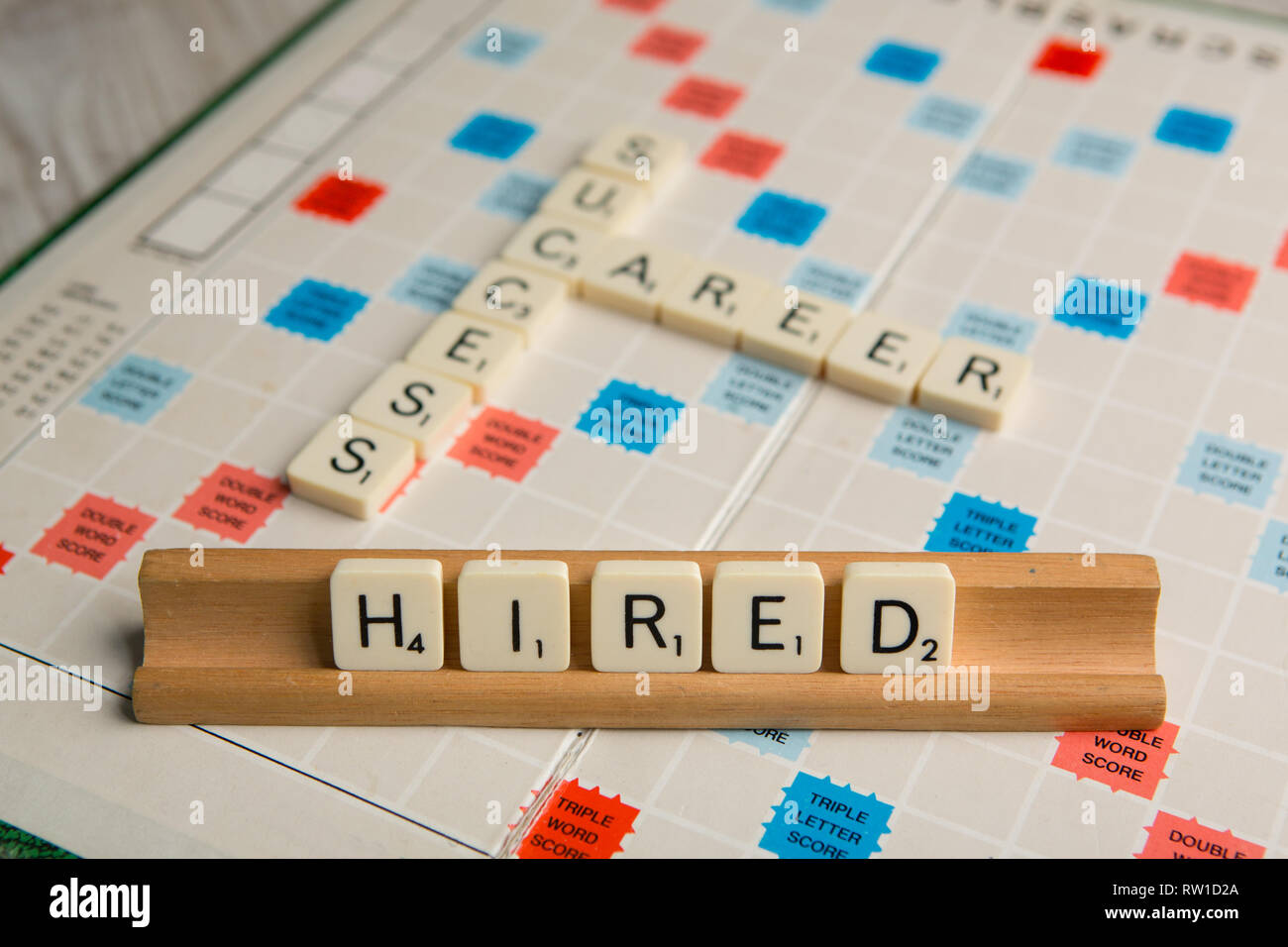 Tiles spell out the word 'hired' Stock Photo