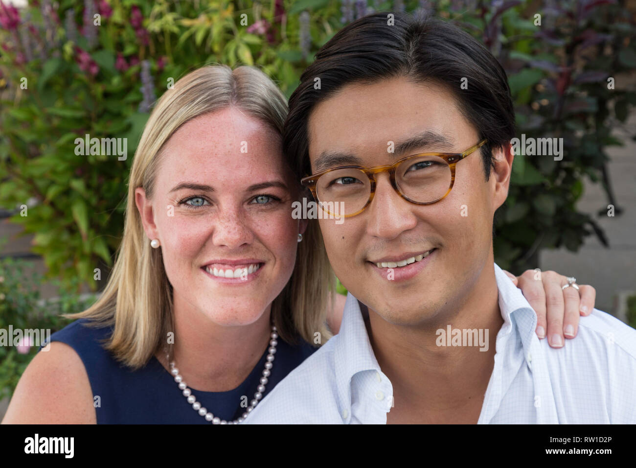 Attractive Mixed Race Couple Pose in Garden, USA Stock Photo