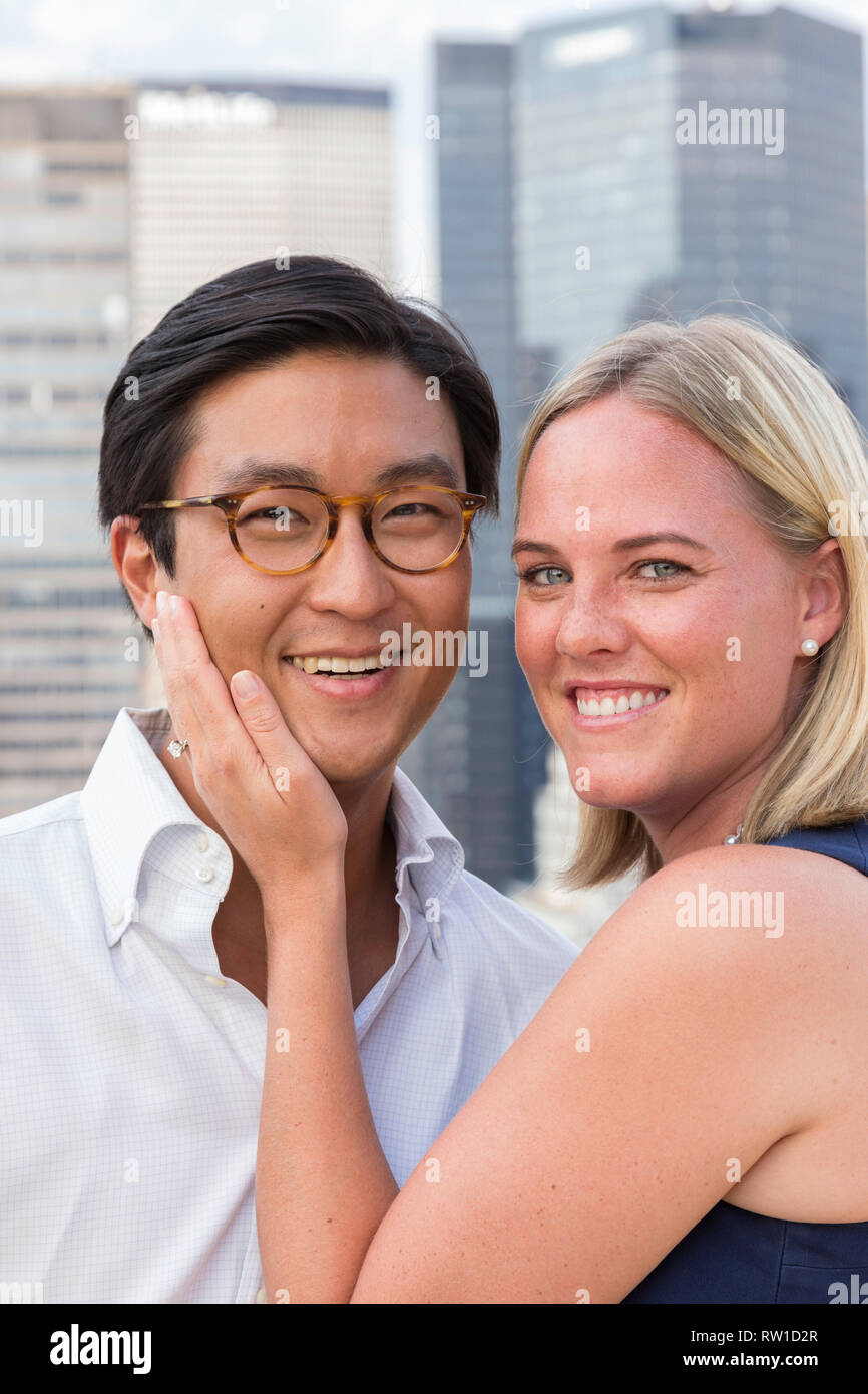 Attractive Mixed Race Couple Pose on Rooftop, NYC, USA Stock Photo