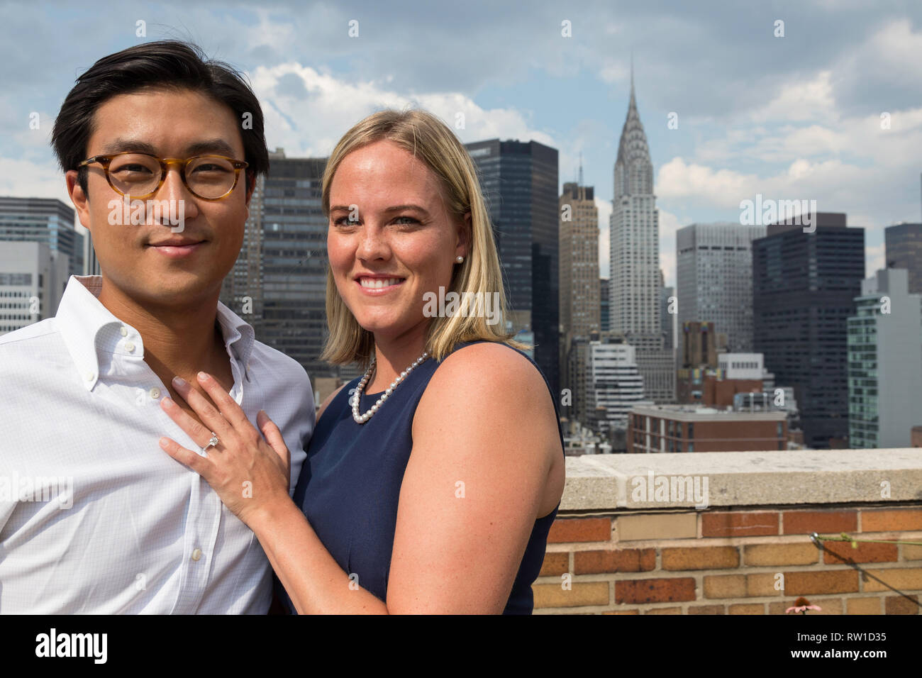 Attractive Mixed Race Couple Pose on Rooftop, NYC, USA Stock Photo