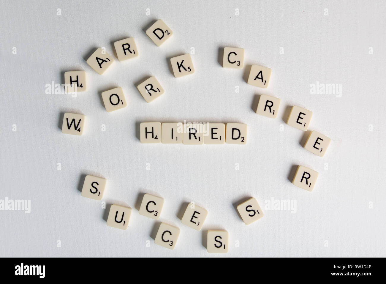 Tiles spell out the word 'hired' Stock Photo