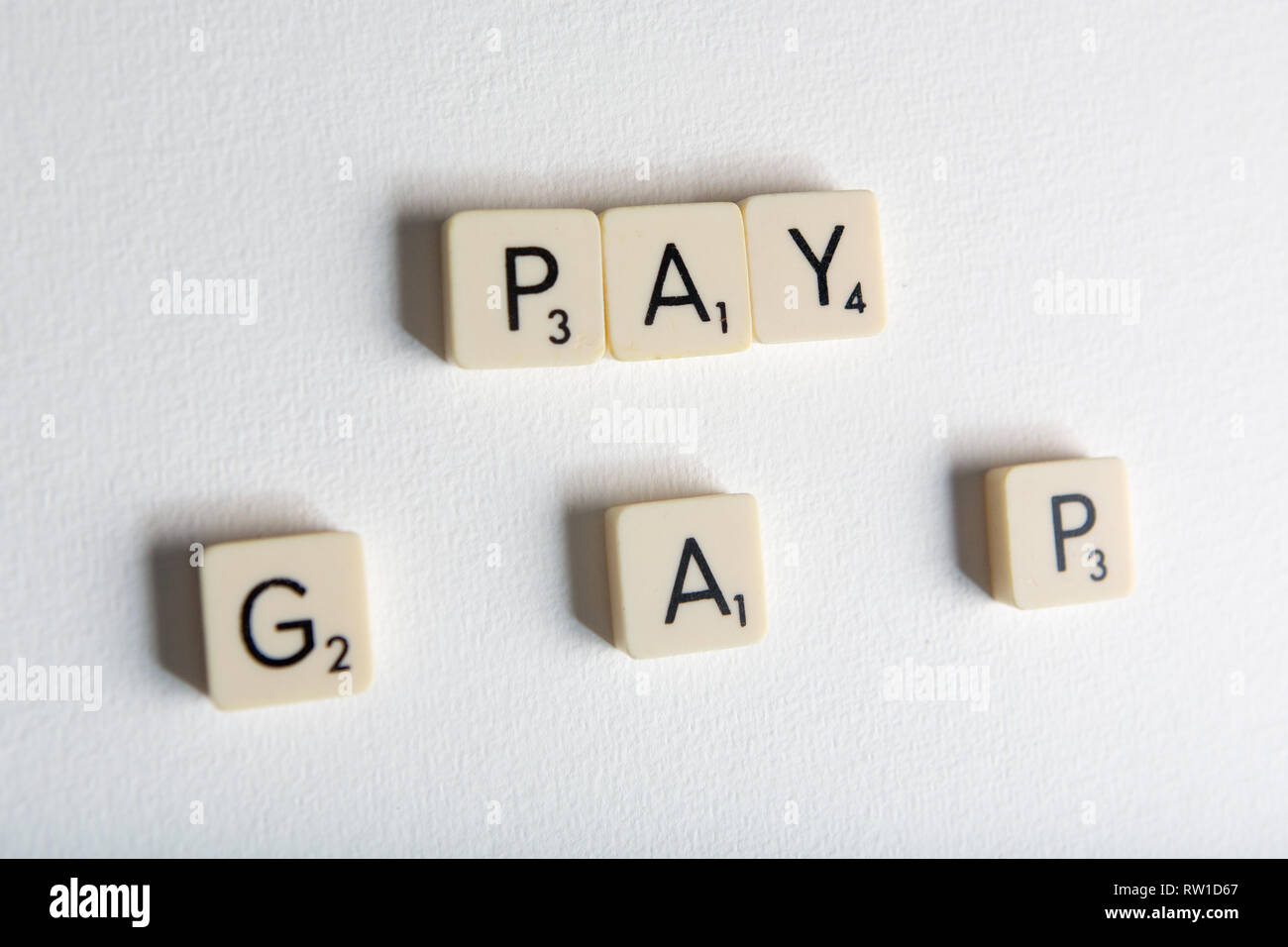 Tiles spell out the words 'pay gap' Stock Photo