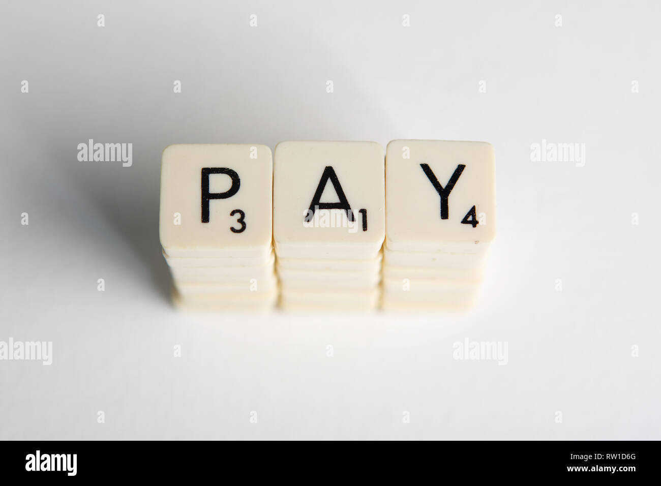 Tiles spell out the word 'pay' symbolizing a pay rise Stock Photo