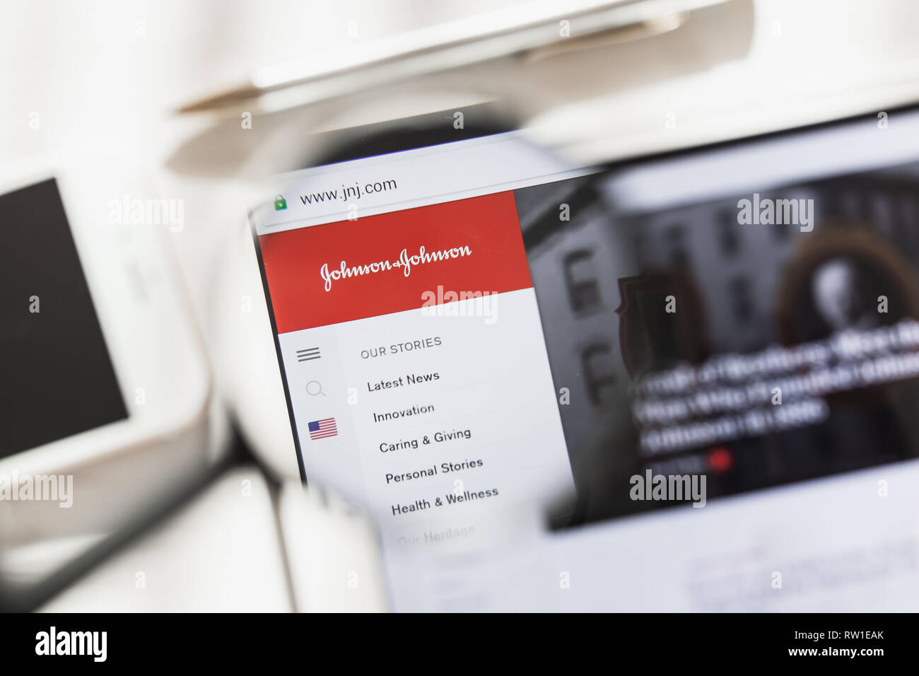 New York, USA - 4 March 2019: Johnson, JNJ, official website homepage under magnifying glass. Concept Johnson, JNJ logo visible on smartphone, tablet Stock Photo