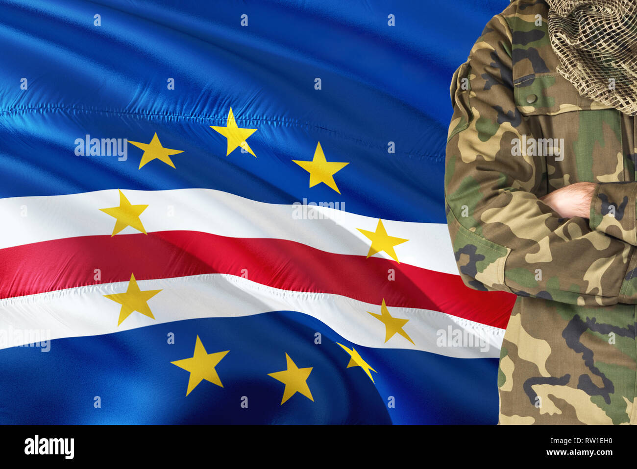 Crossed arms soldier with national waving flag on background - Cape Verde  Military theme Stock Photo - Alamy