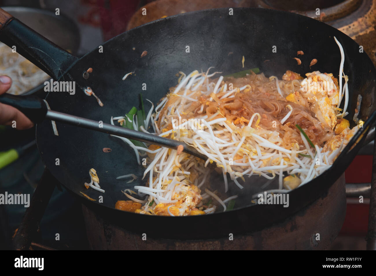 Thai street fast food in hot pan, Pad Thai thai noodle Stock Photo - Alamy