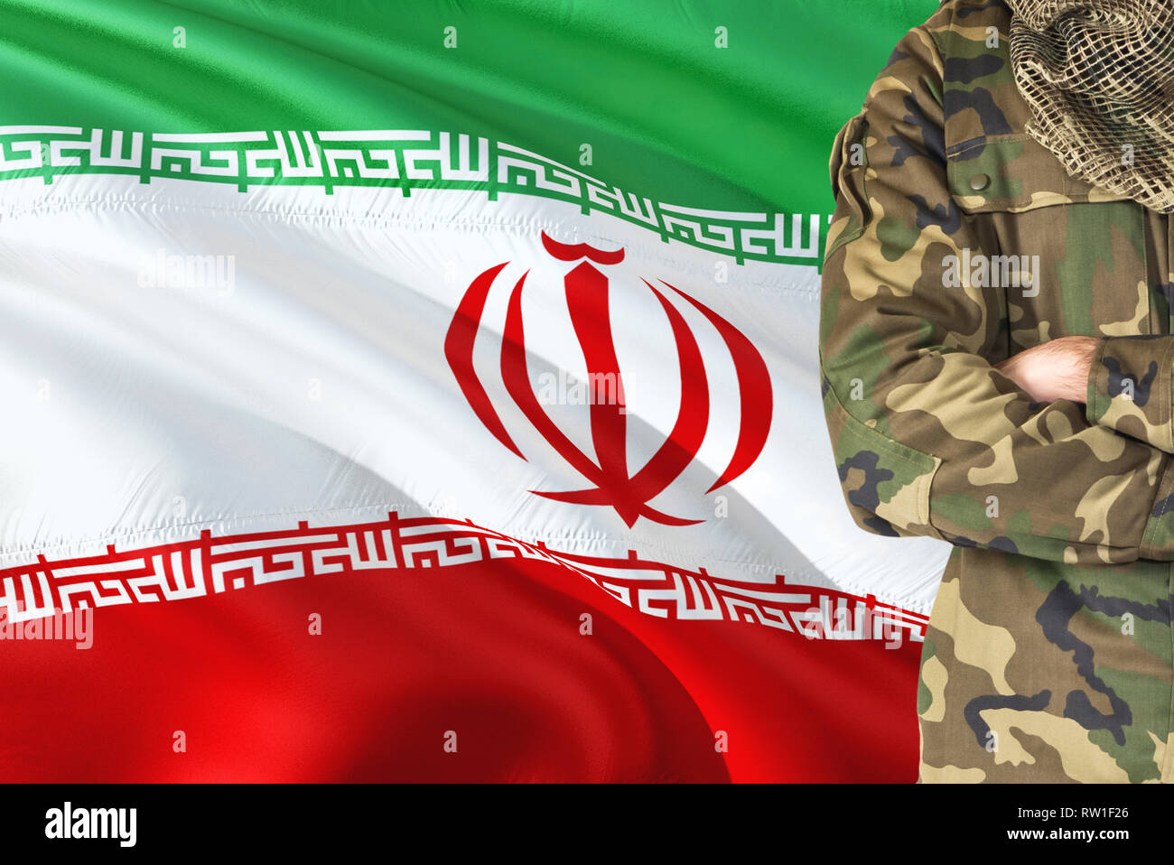 Crossed arms Iranian soldier with national waving flag on background - Iran  Military theme Stock Photo - Alamy