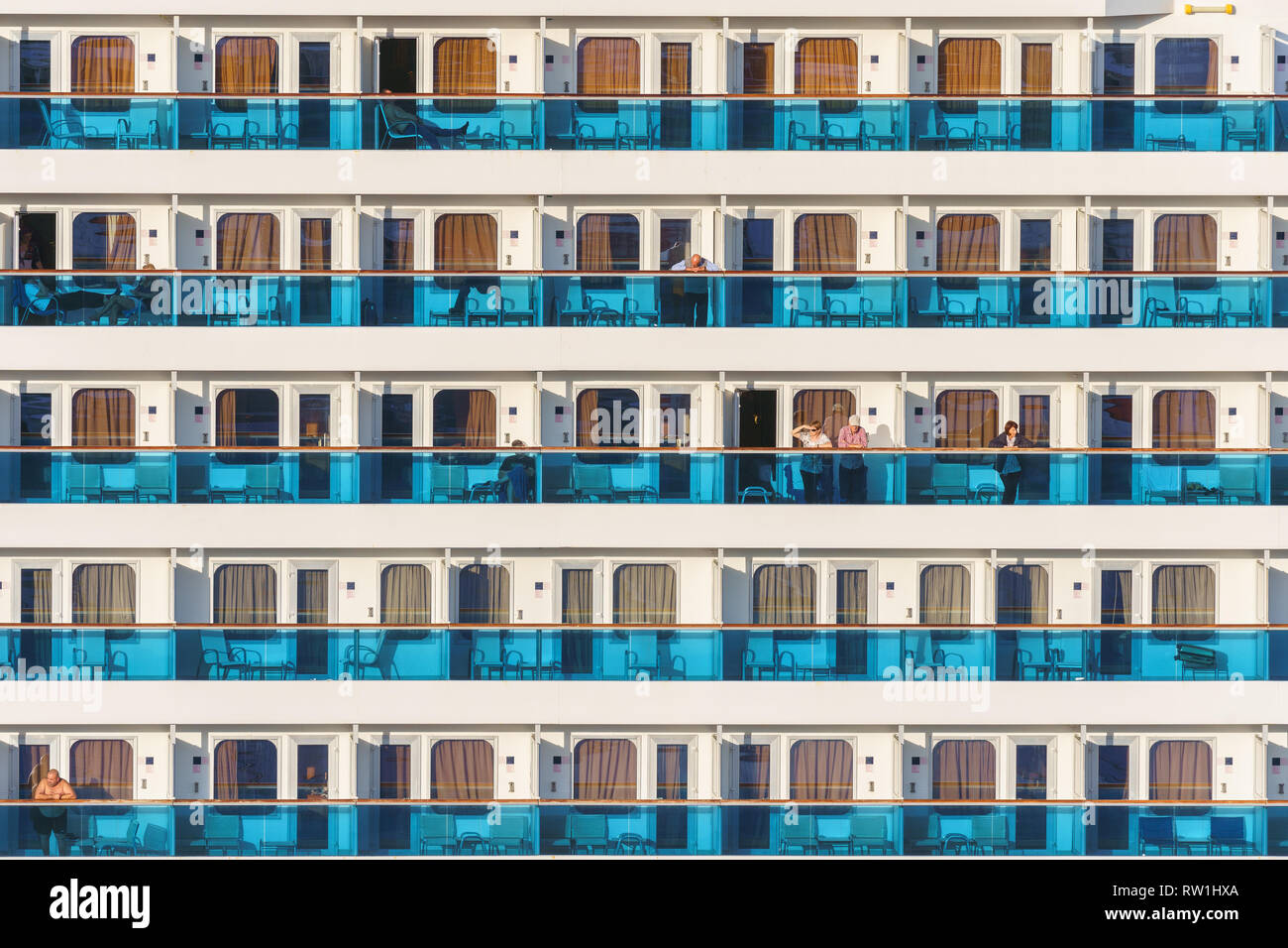 Cruise liner deck of blue and white colored stripes with people ...