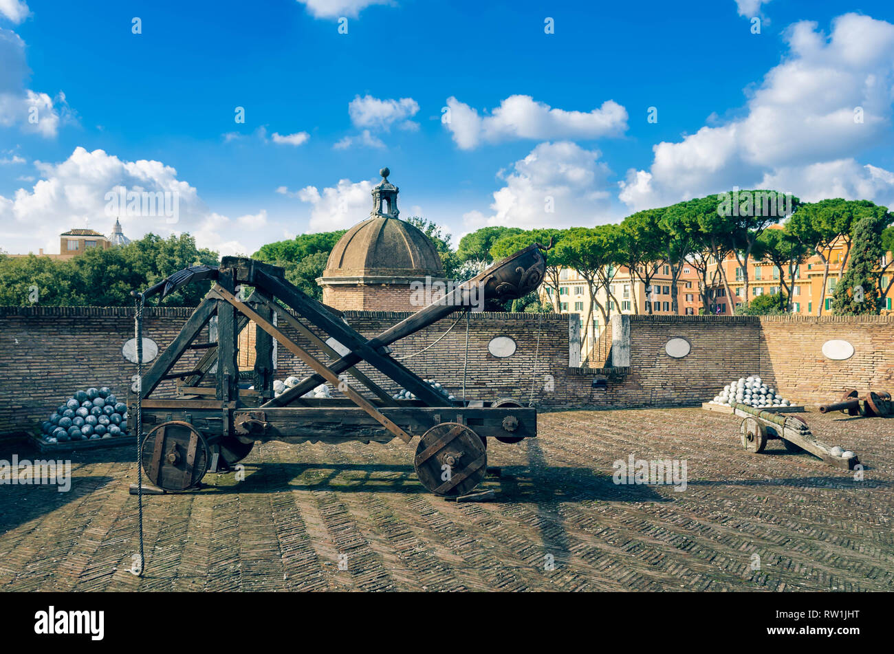 Ancient wooden catapult and cannon balls at  Sant'Angelo Castel. Rome Italy Stock Photo