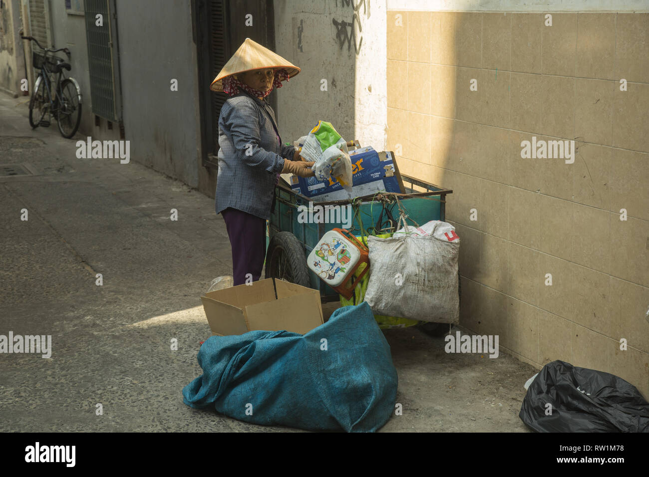 Woman search waste in Ho Chi Minh Stock Photo