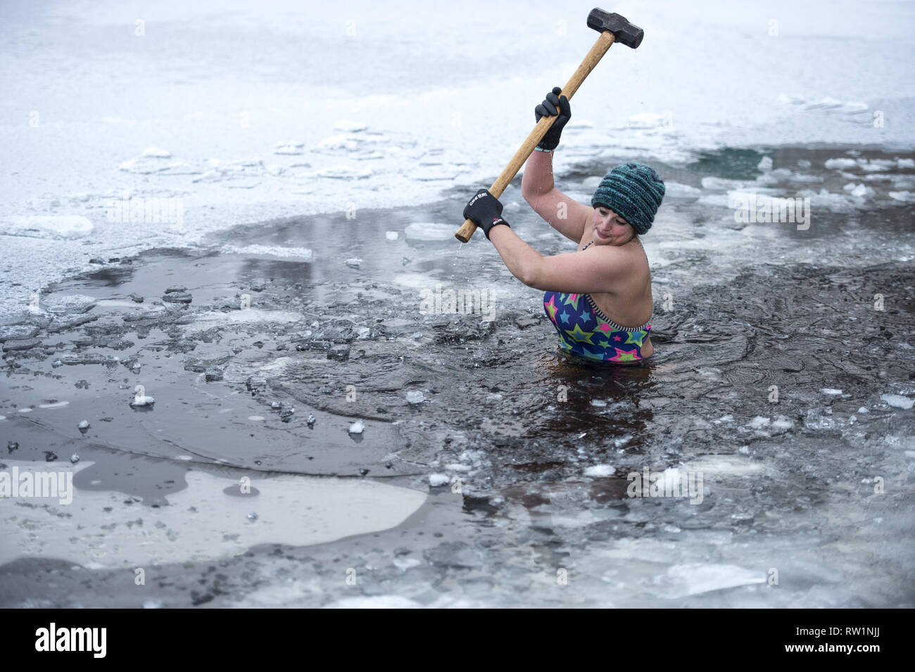 As children across the country enjoy a snow day, wild swimmer Alice  Goodridge gives a whole new meaning to sledging as she takes a hammer to  the frozen waters of Loch Insh