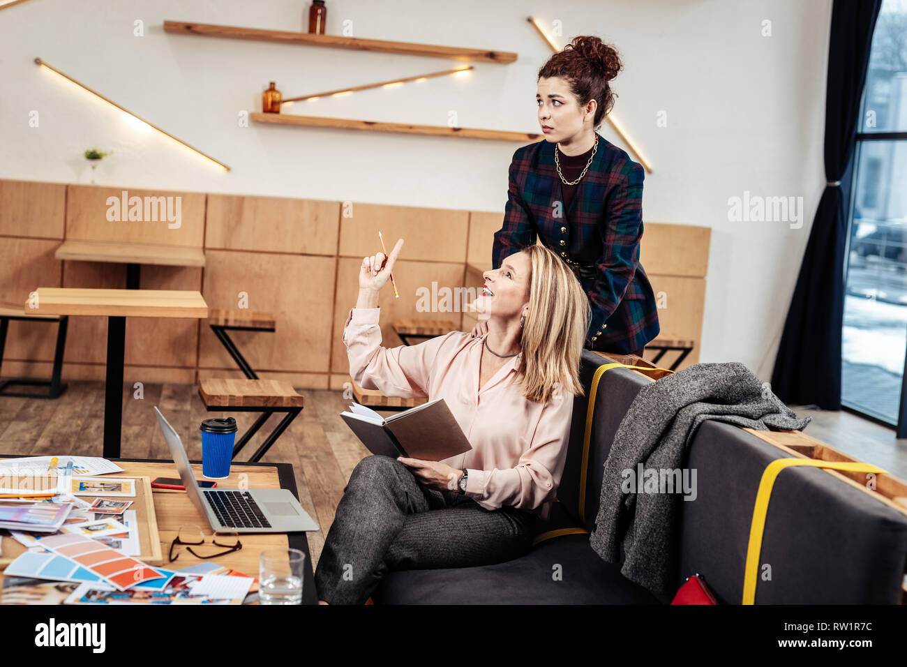 Designer having inspiration while having massage by secretary Stock Photo