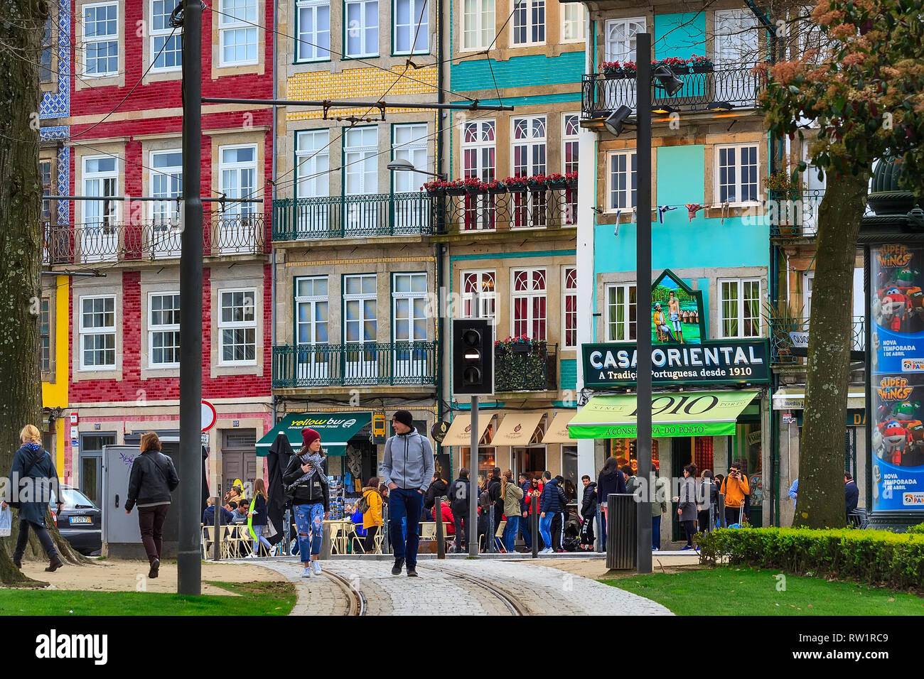 Porto, Portugal -April 1, 2018: Old town street street view with traditional colorful houses, cafe and people Stock Photo