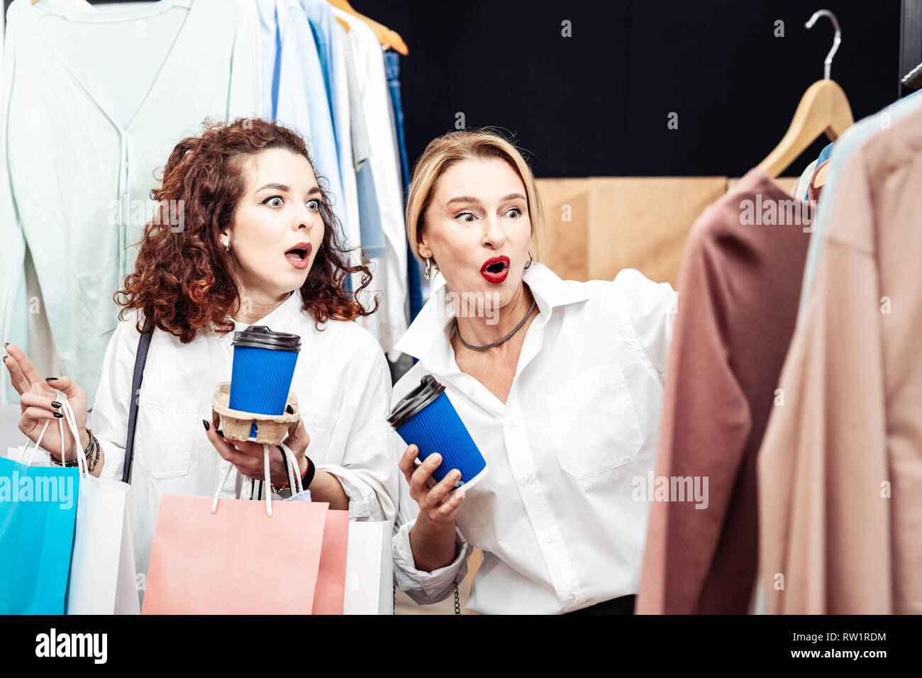 Mother and daughter feeling surprised seeing the price of sweater Stock Photo