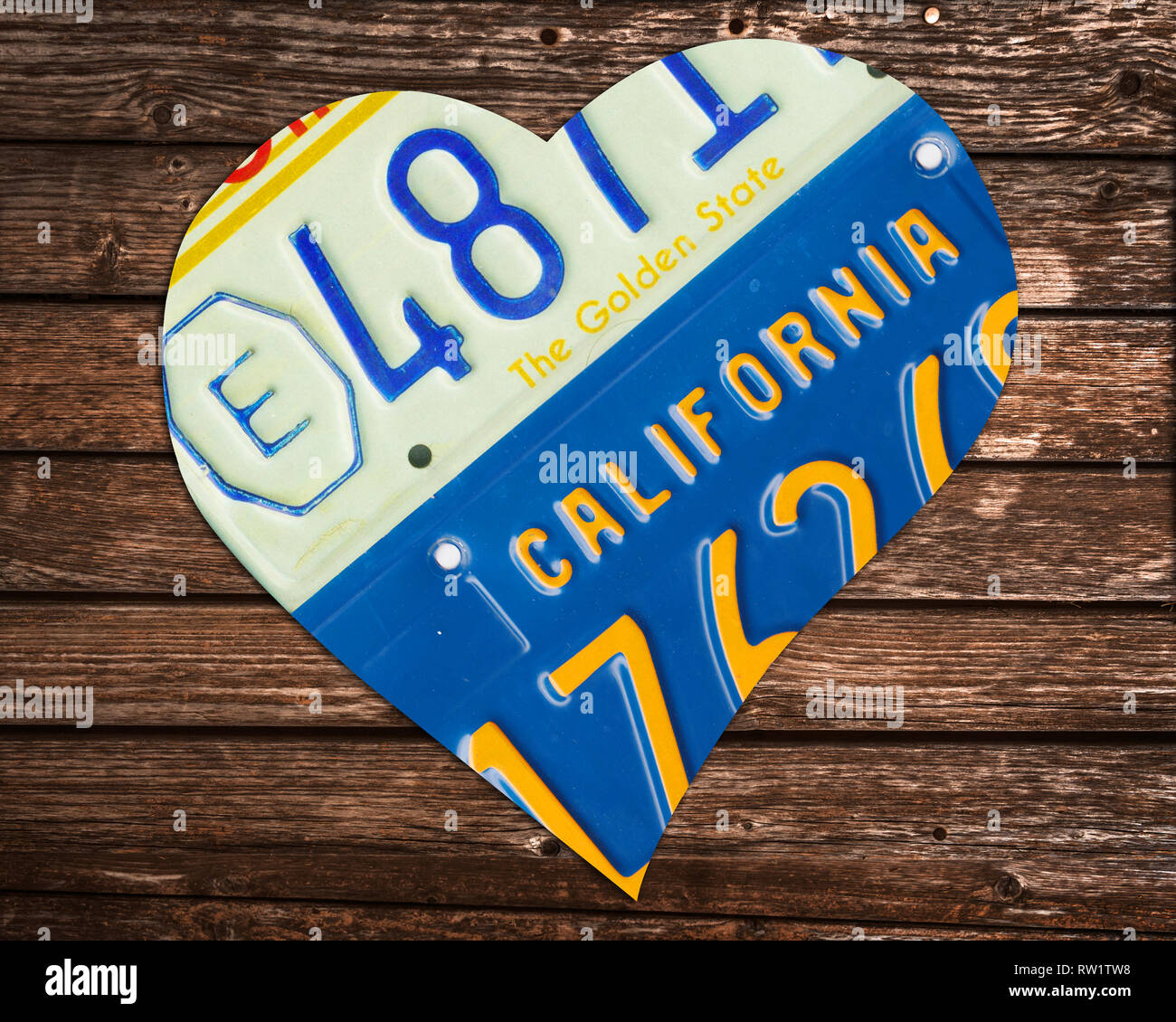 California state license plates in the shape of a heart on wood background Stock Photo