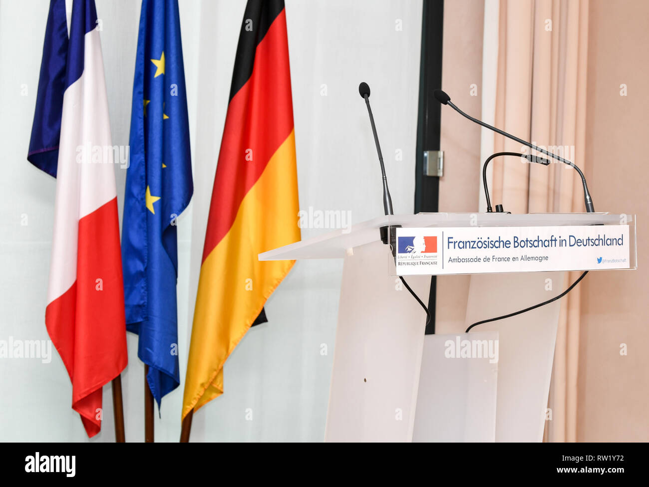 Berlin, Germany. 01st Mar, 2019. A lectern with the inscription 'French Embassy in Germany - Ambassade de France en Allemagne' and the flags of France, Germany and the EU in the French Embassy. Credit: Jens Kalaene/dpa-Zentralbild/dpa/Alamy Live News Stock Photo