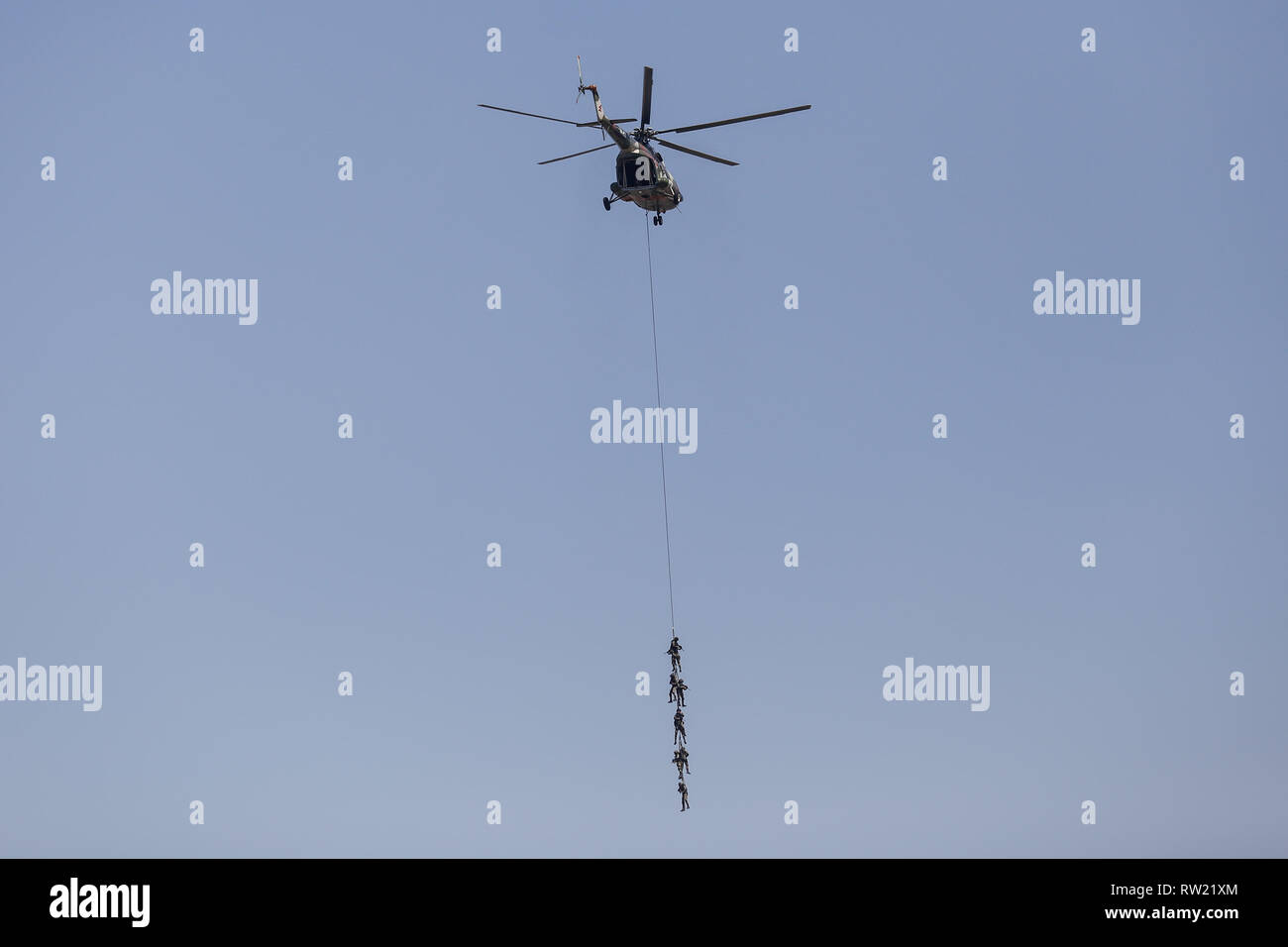 Nepalese Army soldiers demonstrate rescue skills aboard of an helicopter during the Nepal Army Day celebration.  Nepal Army Day is celebrated annually during Hindu festival Shivaratri. Stock Photo