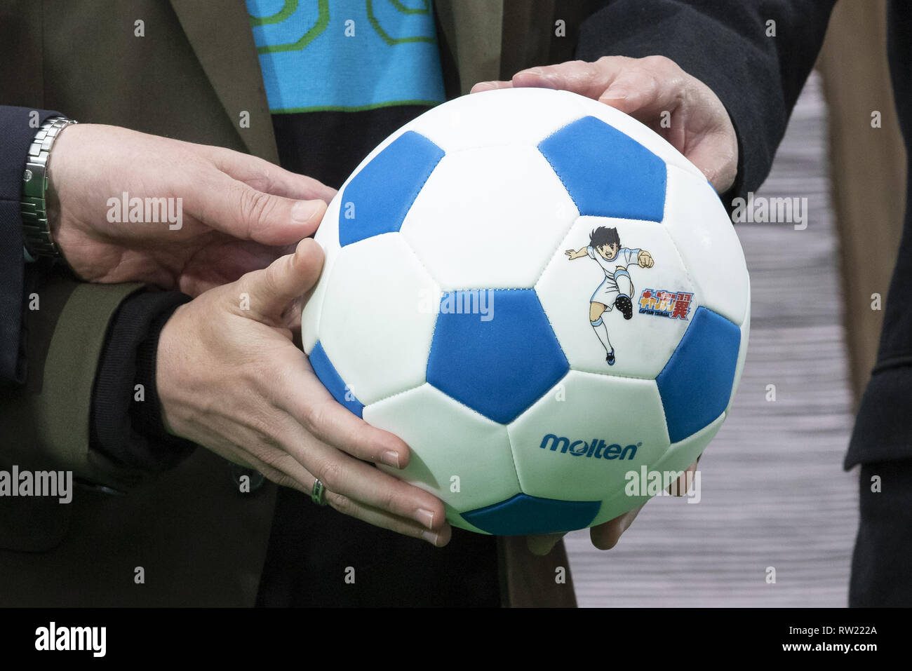 March 4, 2019 - Tokyo, Japan - Barcelona legend playmaker Andres Iniesta and other guests hold a football soccer ball with the image of Captain Tsubasa during an opening ceremony for the Yotsugi Station and Captain Tsubasa project. Iniesta was named Official Collaborator for the Yotsugi Station and Captain Tsubasa project, which aims to promote the tourism in the ward of Katsushika, the hometown of Yoichi Takahashi author of the Captain Tsubasa manga. Iniesta who is playing for the Japanese football club Vissel Kobe also visited the Yotsugi Station to see Captain Tsubasa manga characters decor Stock Photo