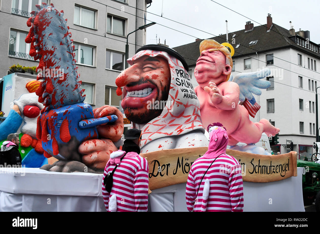 Dusseldorf, Germany. 04th Mar, 2019. Rose Monday procession in Dusseldorf.  Jaques Tilly's theme car: The killer and his guardian angel, the American  President Donald Trump as guardian angel of the Deputy Prime