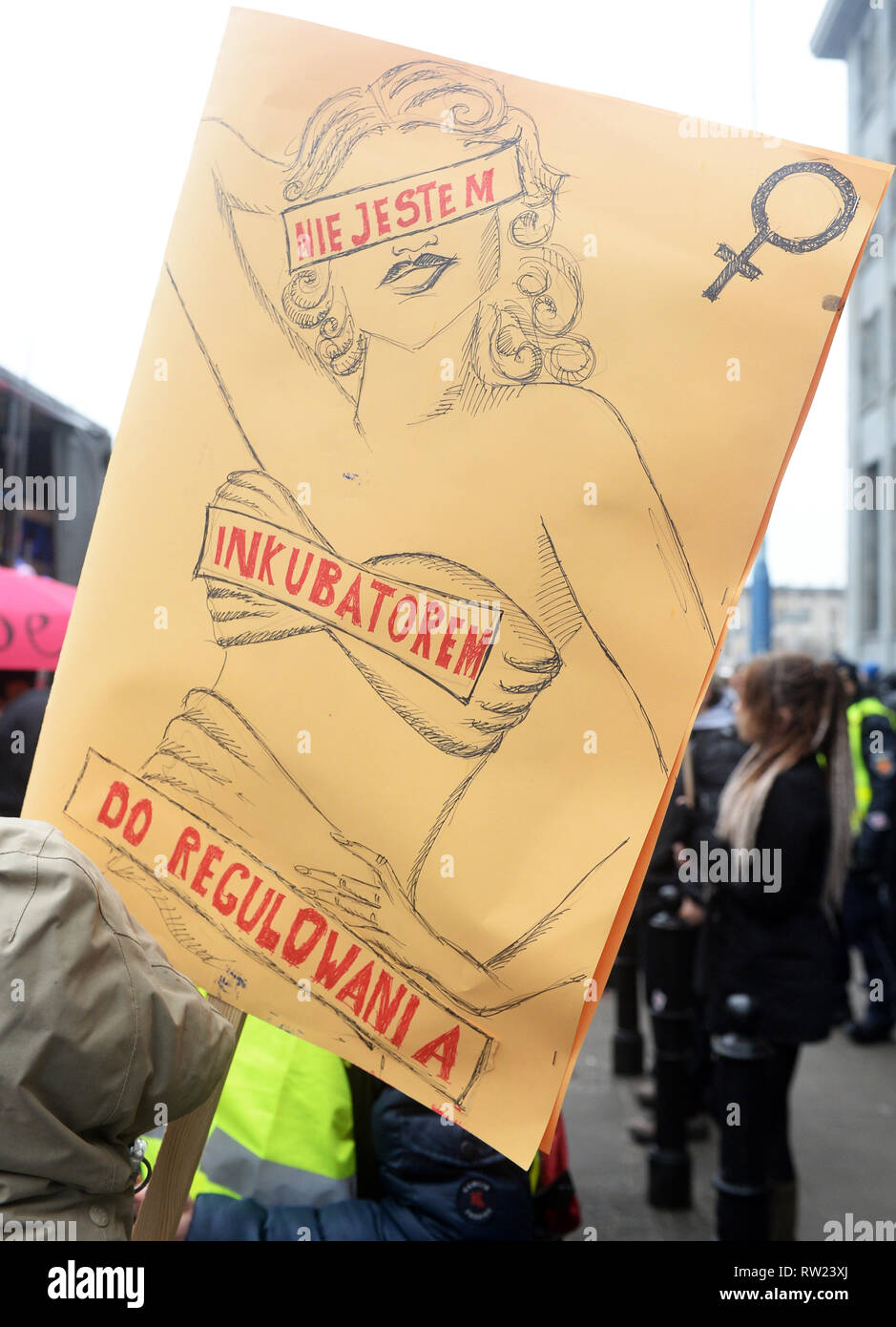 20th Manifa organised by Porozumienie Kobiet 8 Marca, an informal and independent group demanding the equalization for women and correction of Polish law discriminating women, entitled We’re the revolution - 'The law protects the perpetrators', 'We are afraid to ask for help' walks through the streets on March 3, 2019 in Warsaw, Poland.  The poster reads: I'm not an incubator to be adjust. Stock Photo