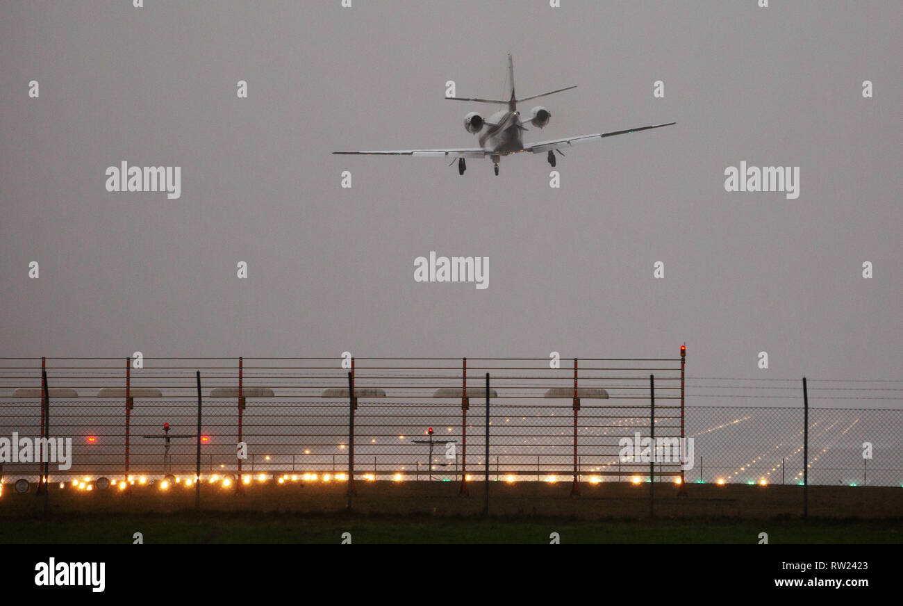 Hannover, Germany. 18th Feb, 2019. An aircraft lands in a clear inclined position at Hannover Airport in strong gusts of wind and heavy rain. Deep 'Bennet' is moving across Germany and is causing stormy weather. Credit: Raphael Knipping/dpa/Alamy Live News Stock Photo