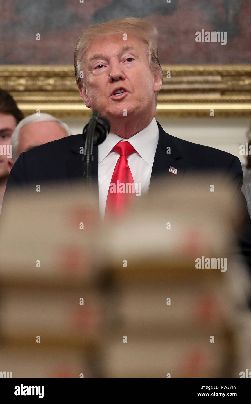 Washington, DC. 4th Mar, 2019. United States President Donald J. Trump, speaks behind a table full of McDonald's hamburgers, Chick fil-a sandwiches and some other fast food as he welcomes the 2018 Division I FCS National Champions: The North Dakota State Bison in the Diplomatic Room of the White House on March 4, 2019 in Washington, DC. Credit: Oliver Contreras/Pool via CNP | usage worldwide Credit: dpa/Alamy Live News Stock Photo