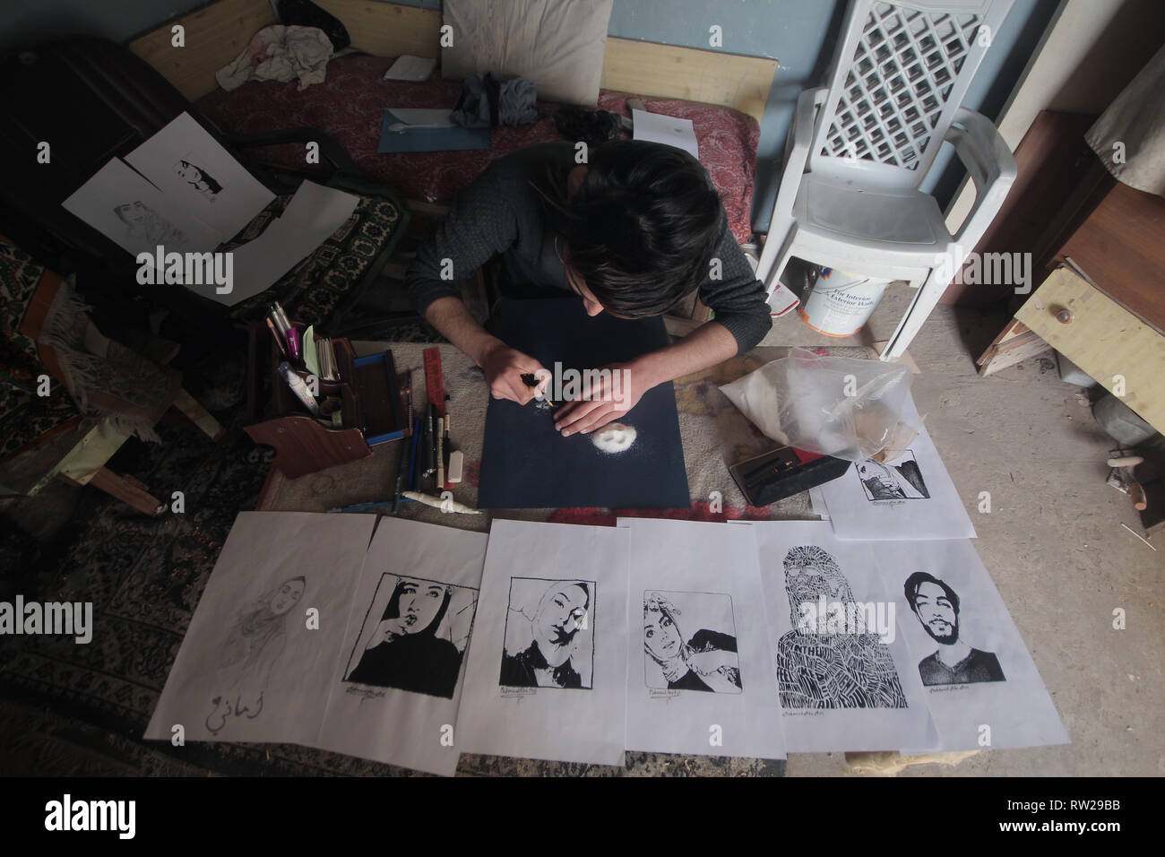 March 3, 2019 - Gaza, ???? ???????/????, Palestine - Mahmoud Abu Assi, 20, a Palestinian artist who supports his family as a painter and calligrapher at his home in Gaza City, in the absence of job opportunities and the worsening economic situation and the siege at the Gaza Strip. Credit: Yousef Masoud/SOPA Images/ZUMA Wire/Alamy Live News Stock Photo