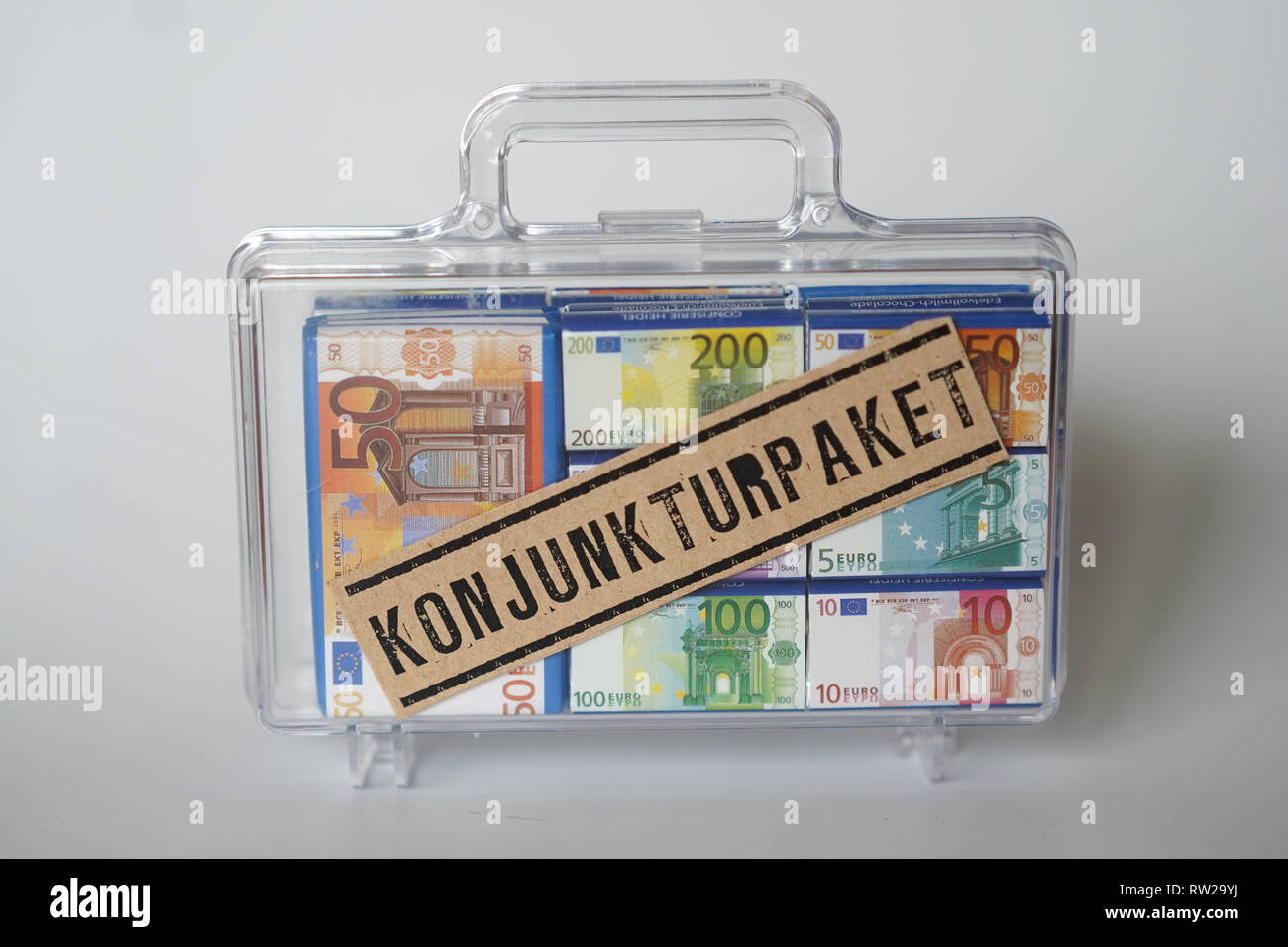 Berlin, Germany. 04th Mar, 2019. View of a transparent suitcase with banknotes and the inscription 'Konjunkturpaket' (economic stimulus package). Credit: Jörg Carstensen/dpa/Alamy Live News Stock Photo