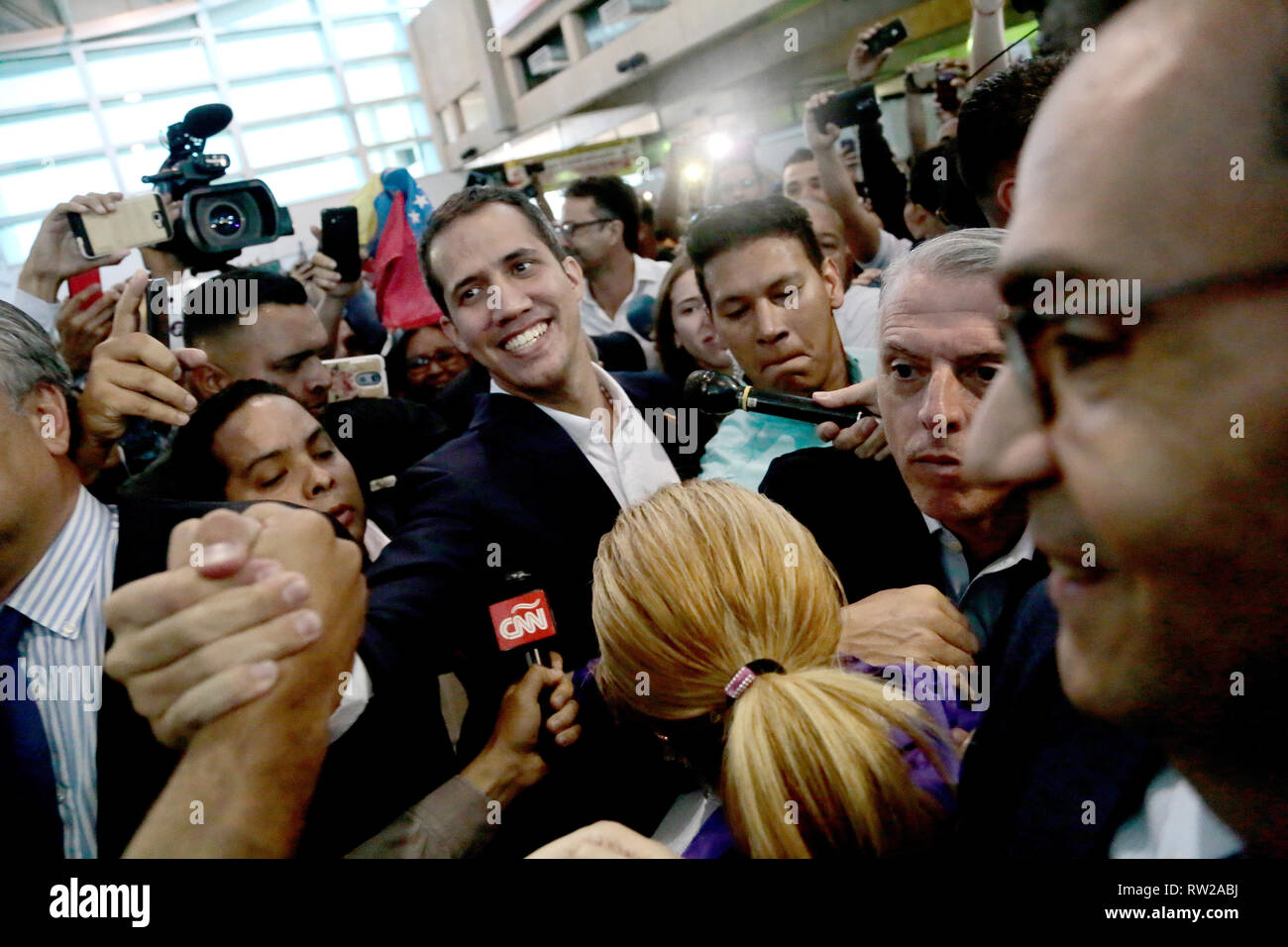 Caracas, Venezuela. 04th Mar, 2019. 04 March 2019, Venezuela, Maiquetía: Juan Guaido (M), self-proclaimed interim president of Venezuela, is welcomed by supporters upon his arrival at Simon Bolivar International Airport. Guaido has returned to Venezuela after about one and a half weeks. Photo: Rafael Hernandez/dpa Credit: dpa picture alliance/Alamy Live News Stock Photo