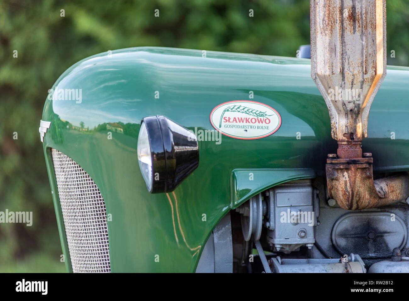 Close up shot of the Slawkowo brand logo and the side of a green tractor. Broniewo, Kuyavian-Pomeranian Voivodeship, Poland Stock Photo