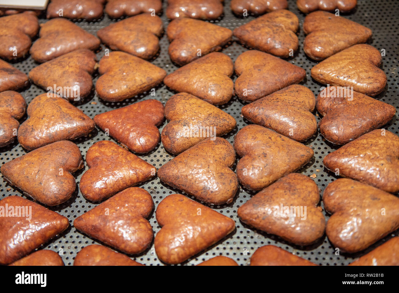 Heart shaped gingerbread lays in rows after being baked. Toruń, Kuyavian-Pomeranian Voivodeship, Poland Stock Photo