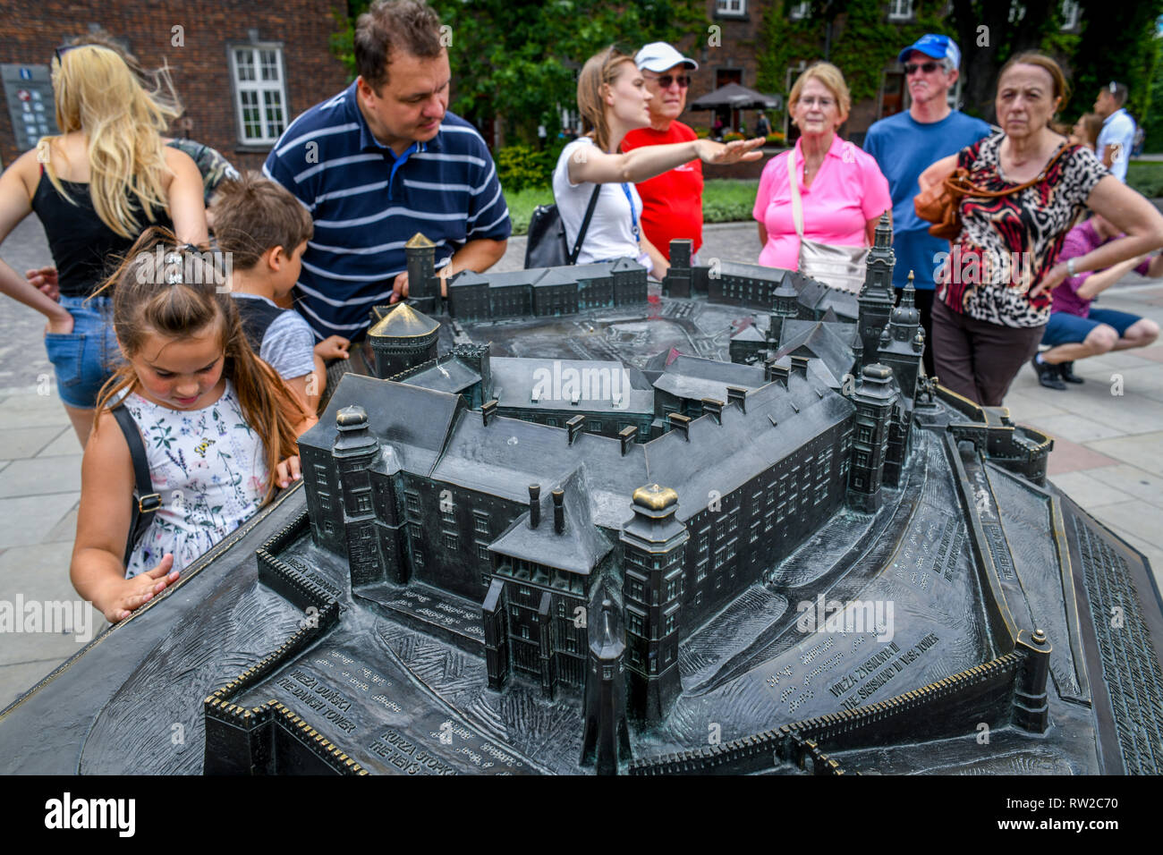 People gather to look at bronze scale model of Wawel Royal Castle, Krak—w, Lesser Poland Voivodeship, Poland. Stock Photo