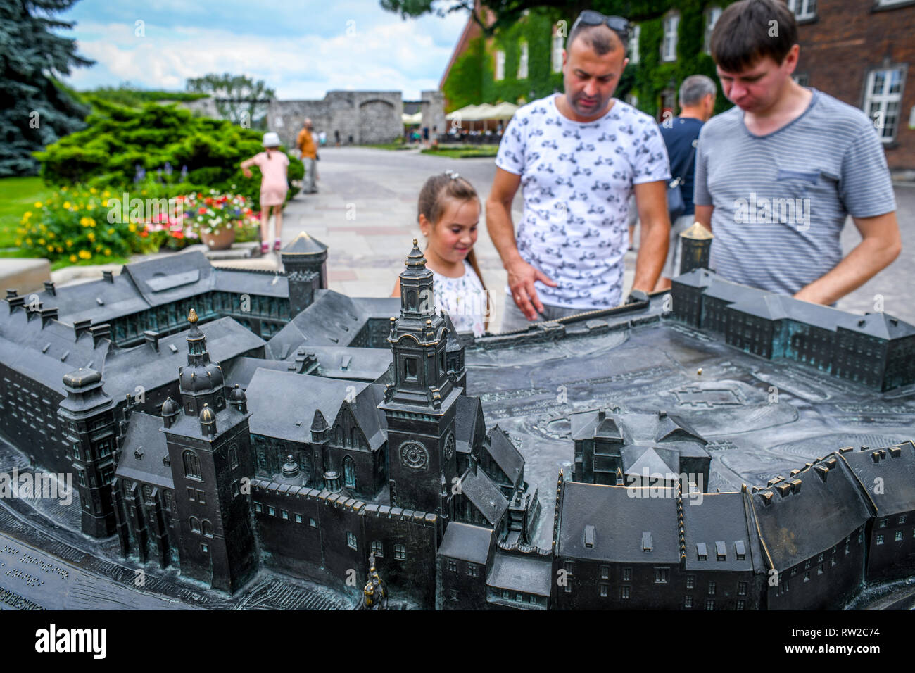 People gather to look at bronze scale model of Wawel Royal Castle, Krak—w, Lesser Poland Voivodeship, Poland. Stock Photo