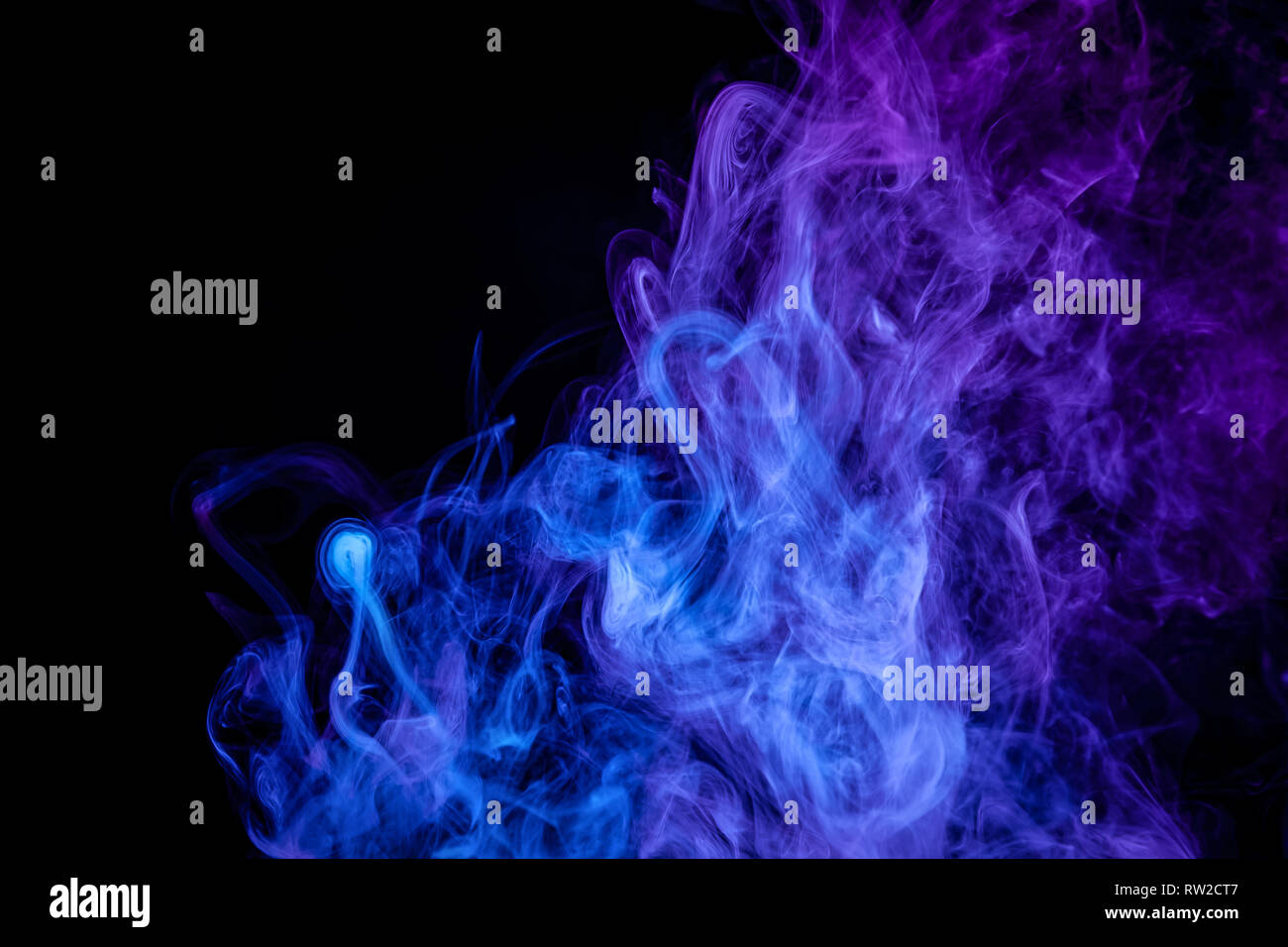 Blue and purple bomb smoke on black isolated background Stock Photo - Alamy