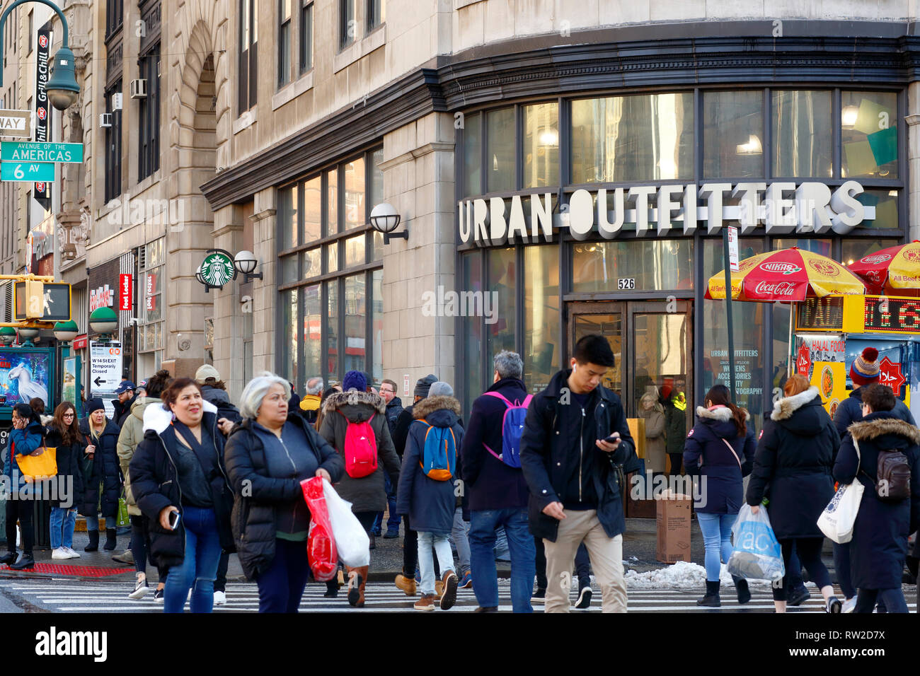 People, shoppers at 14th St and 6th ave in Manhattan in New York City with an Urban Outfitters on the corner. (March 2, 2019) Stock Photo