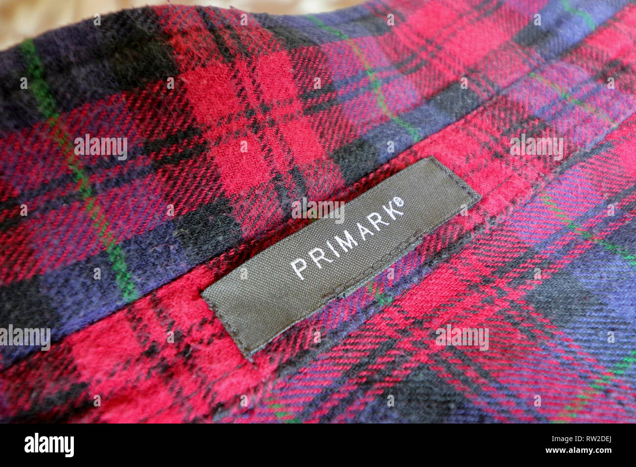BRAUNSCHWEIG, LOWER SAXONY, GERMANY - MARCH 4, 2019: Fabric Primark tag. Primark textile label stitched on unisex shirt in Lumberjack design. Stock Photo