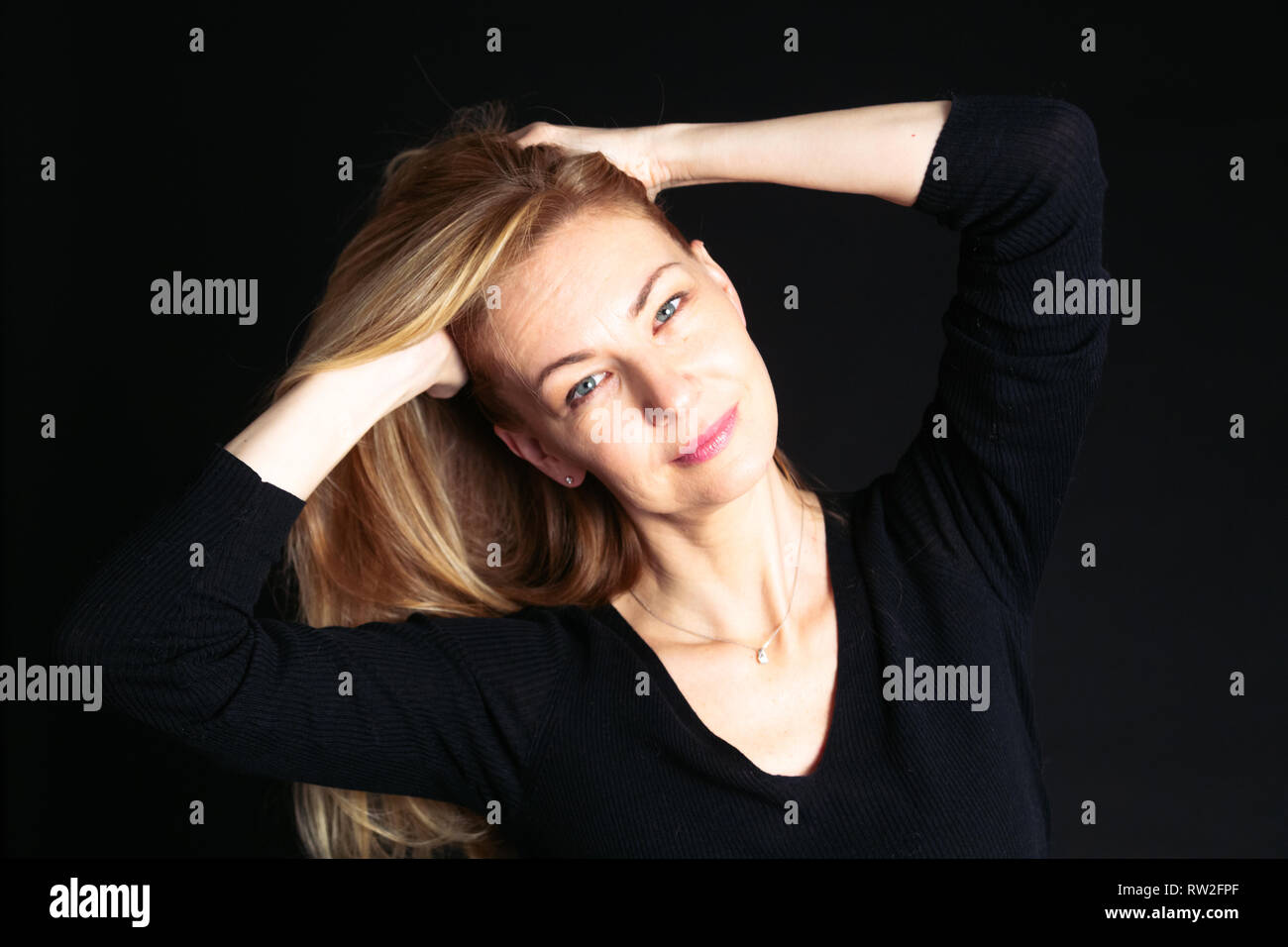 Close up studio portrait of a beautiful woman in the black dress ...