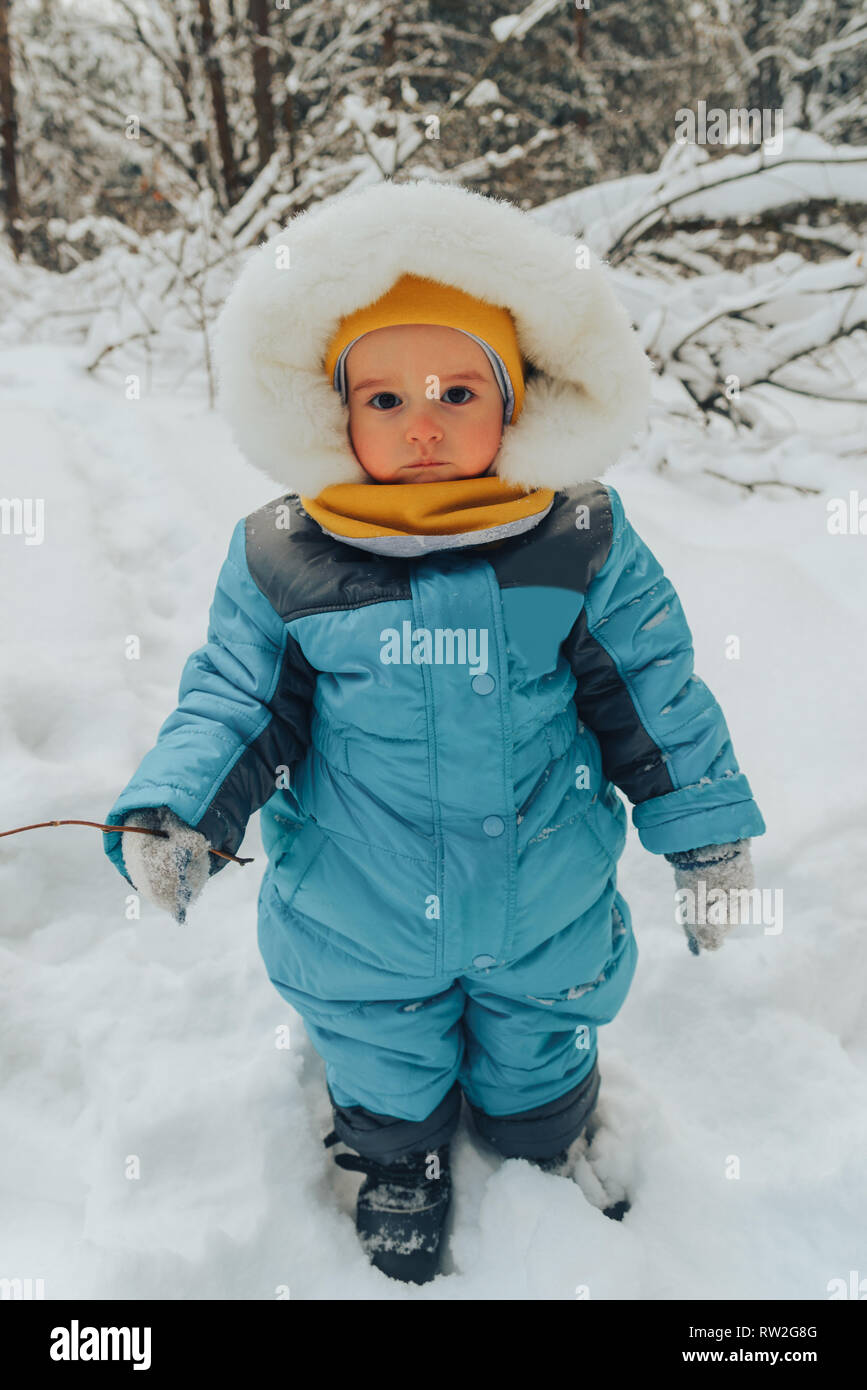 A child for a walk in the winter. Kid in winter clothes. Family walks
